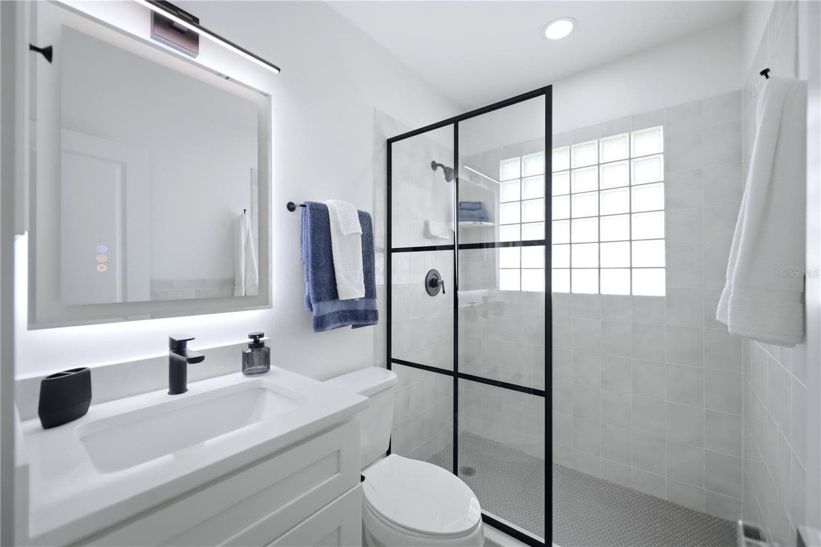 Updated second bathroom modern vanity, shower and bright white finishes - 6103 CARLTON AVE, SARASOTA