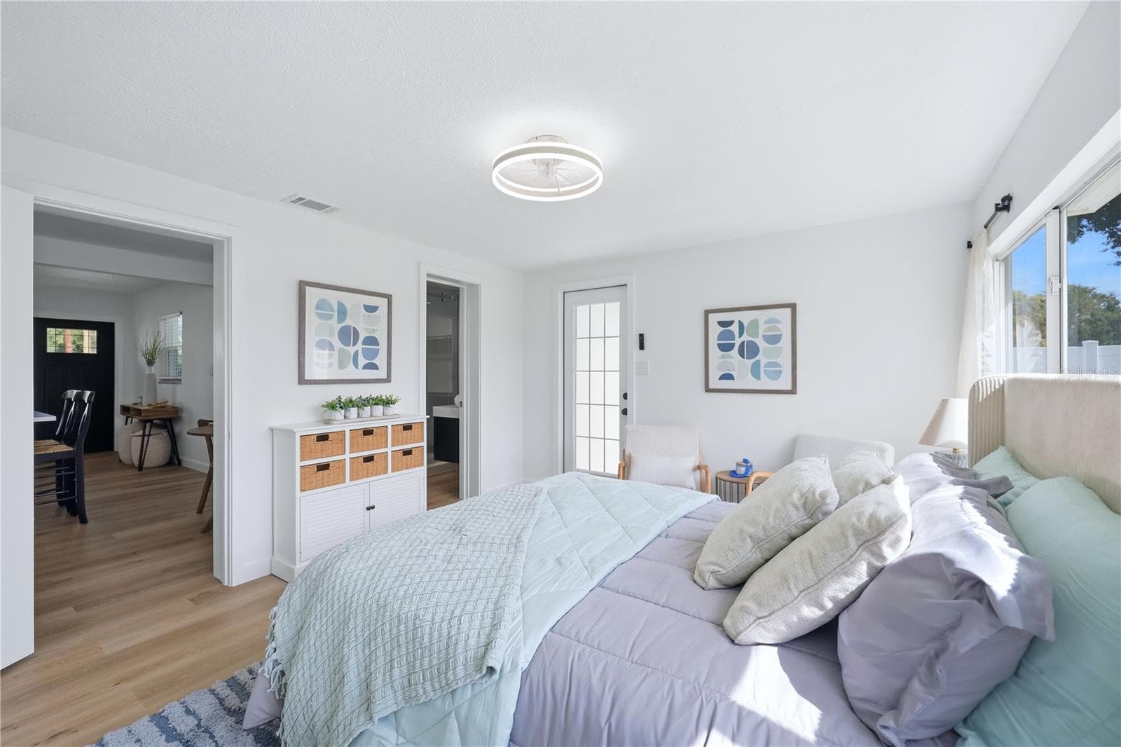 Bright bedroom with ceiling fan, neutral finishes and abundant natural light - 6103 CARLTON AVE, SARASOTA