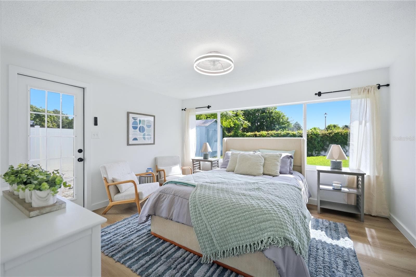 Spacious primary bedroom with natural light, ceiling fan and renovated interior - 6103 CARLTON AVE, SARASOTA
