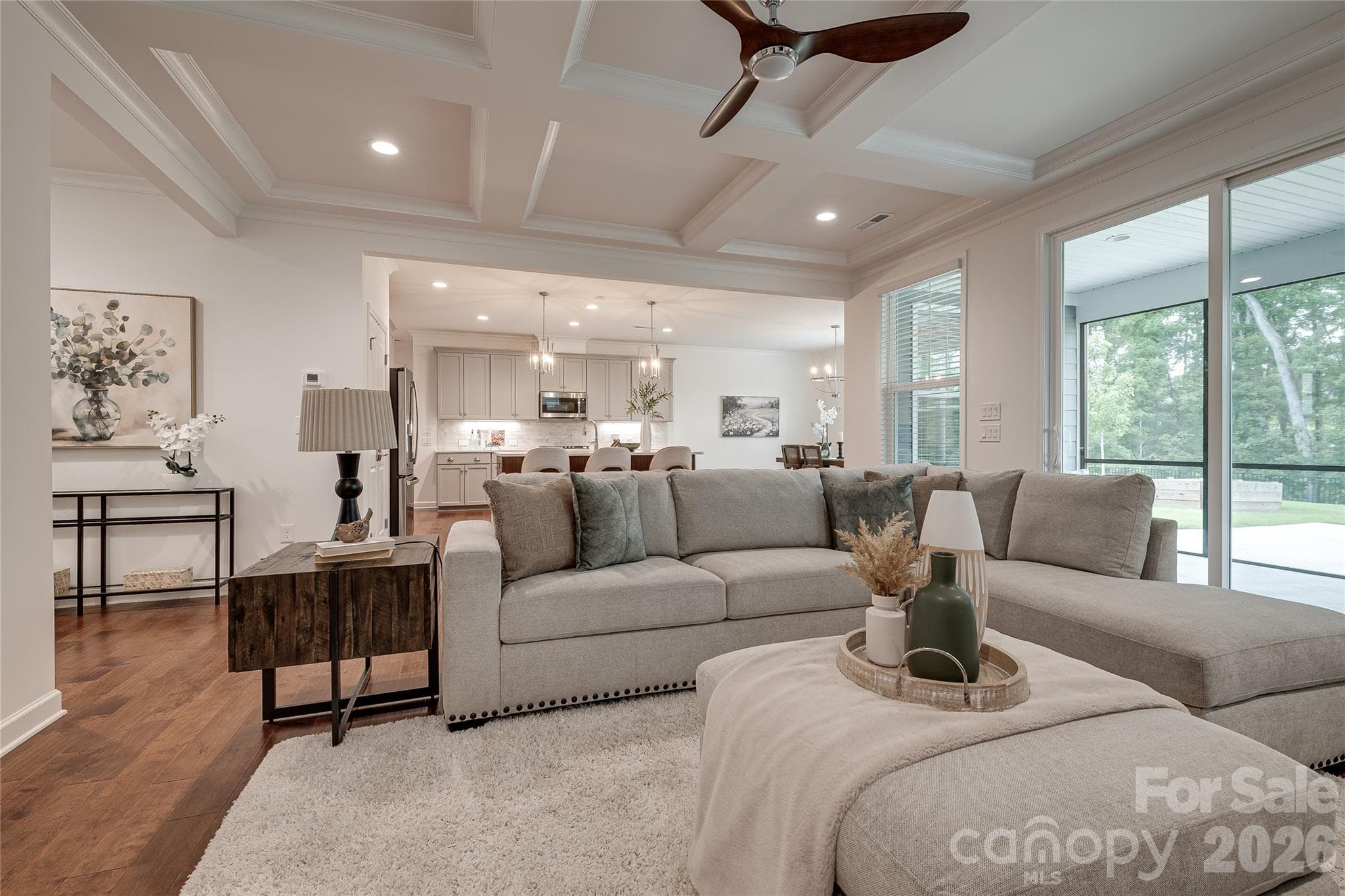 Upgrades in the Family Room include a coffered ceiling and prefinished engineered thick hardwood flooring - 2566 NW Red Hill Street, Concord