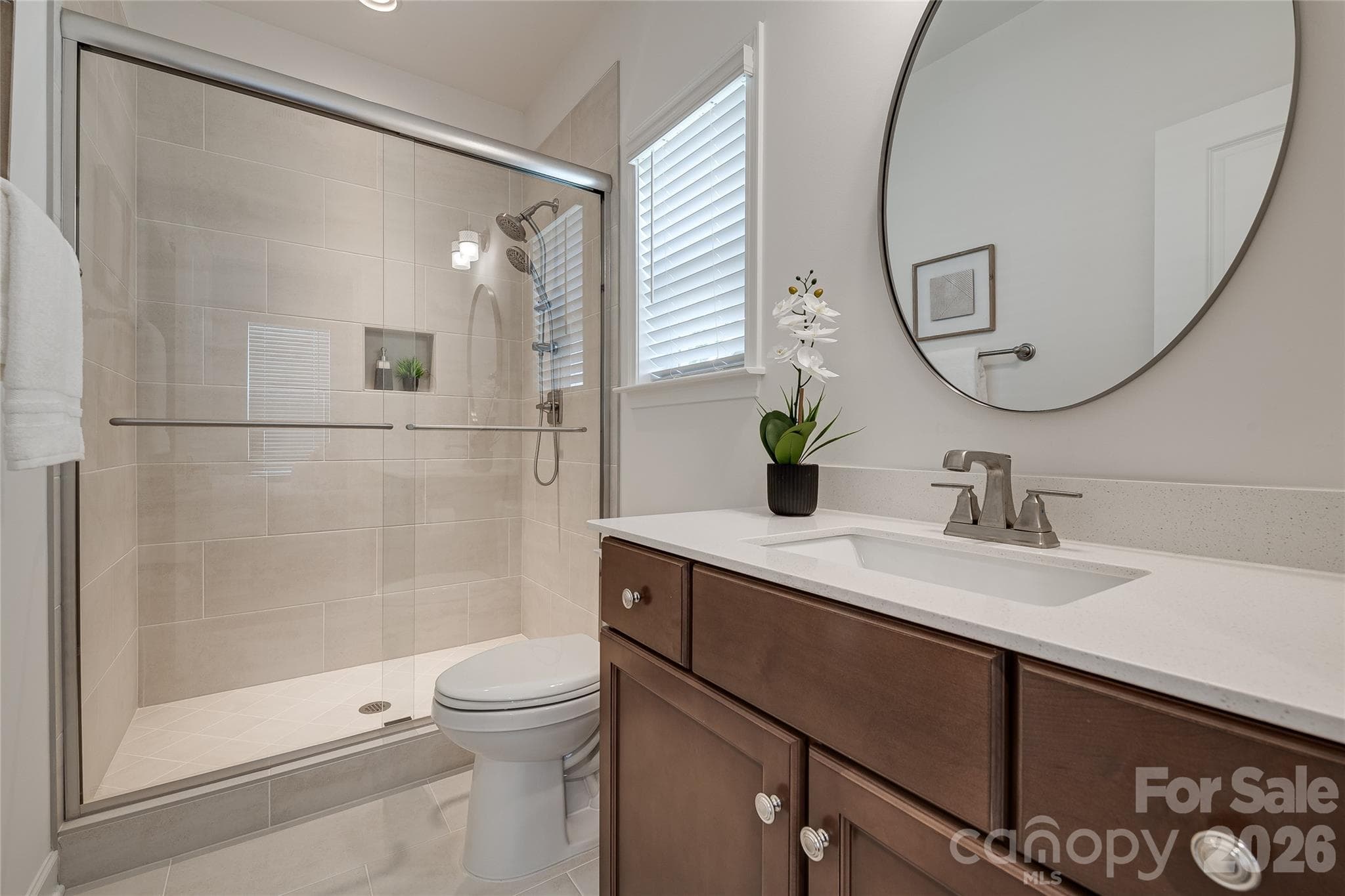 Upgrade of a tiled walk-in shower in this en suite guest bath. All toilets were upgrade to comfort height. - 2566 NW Red Hill Street, Concord