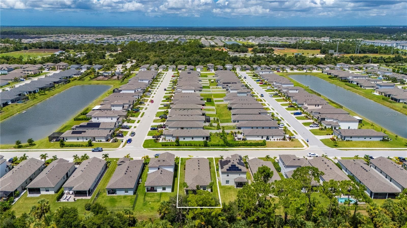 Rear view of the home and view to the west. Explore the West Port Communities. - 1968 SUNSET PRESERVE WAY, PORT CHARLOTTE