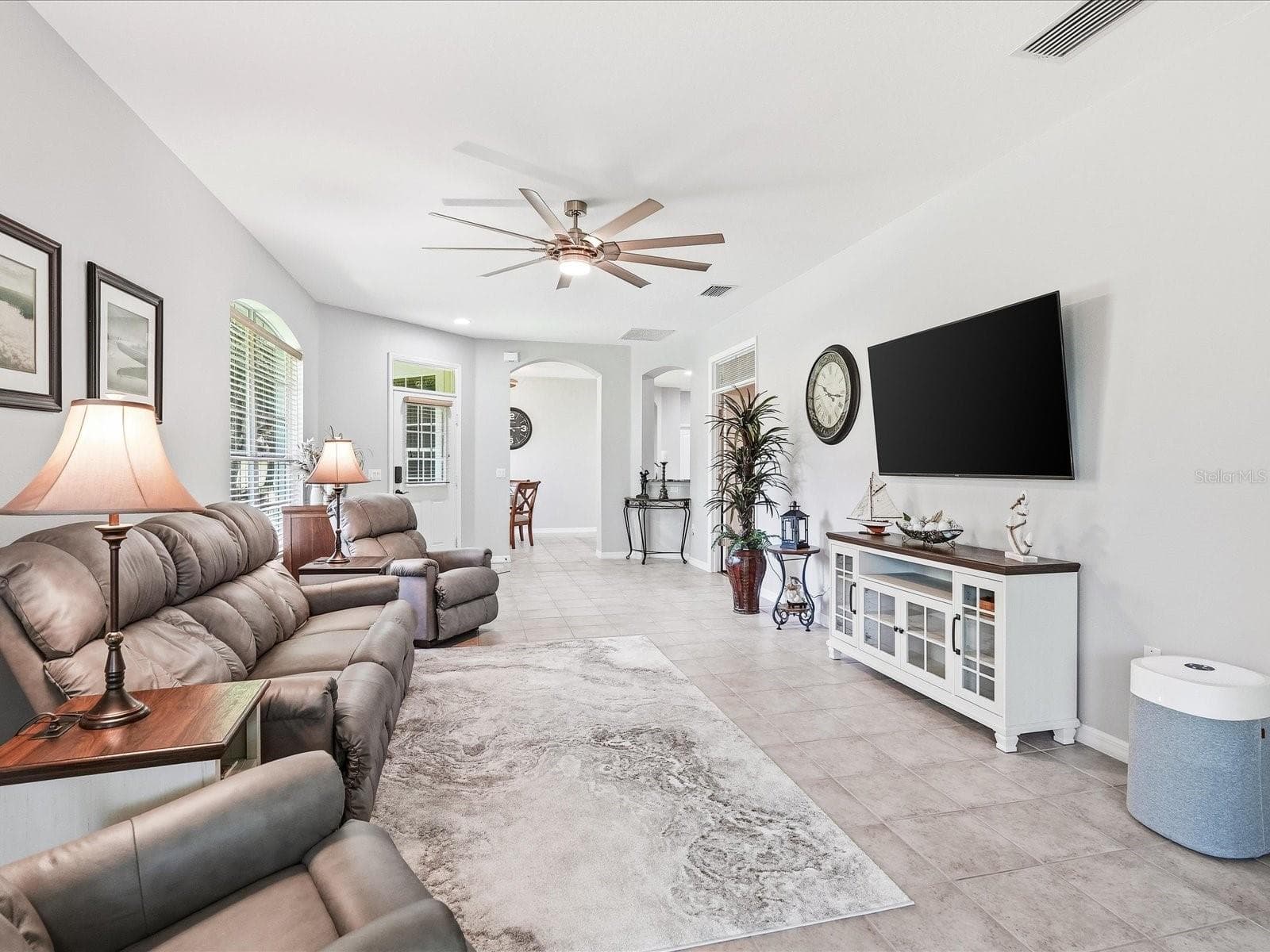 Living area facing toward dining area - 4693 WHISPERING OAKS DR, NORTH PORT