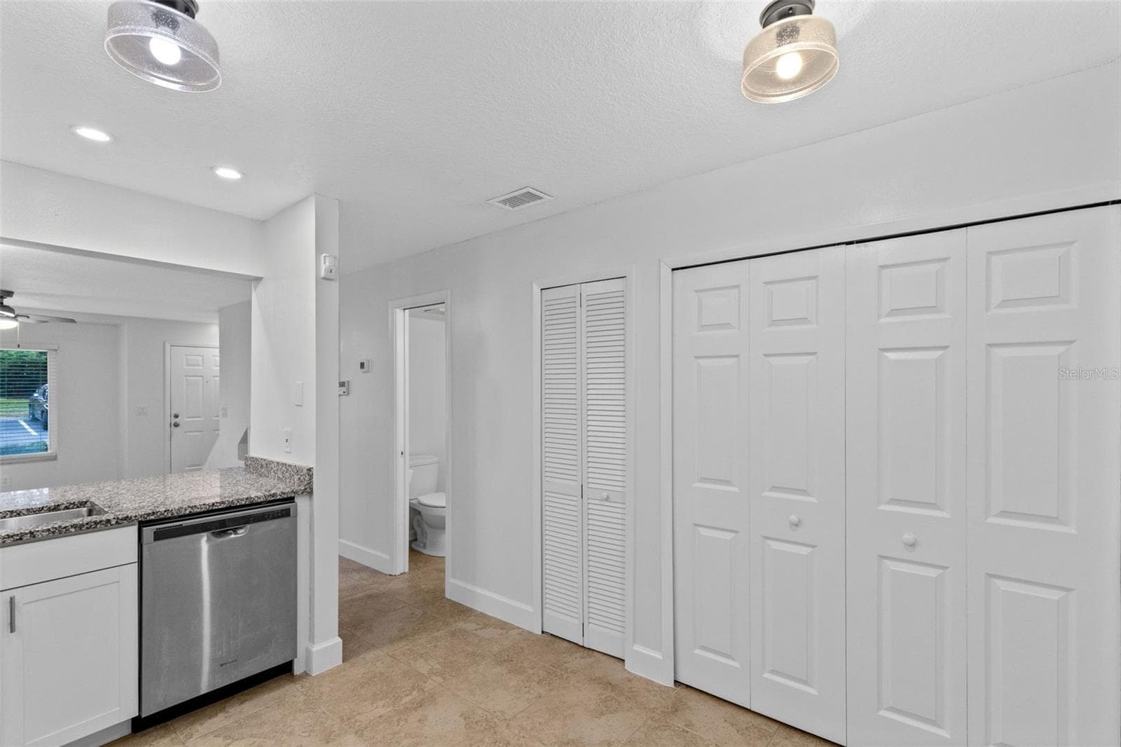 The updated kitchen features white cabinetry, granite countertops, stainless steel appliances and a breakfast bar overlooking the living and dining space. Interior laundry, washer and dryer included, and an additional downstairs storage closet complete the first floor. - 283 SANDLEWOOD TRL #3, WINTER PARK