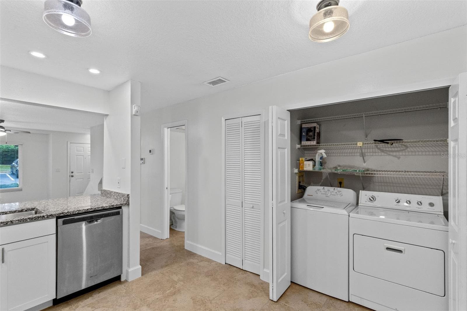 The updated kitchen features white cabinetry, granite countertops, stainless steel appliances and a breakfast bar overlooking the living and dining space. Interior laundry, washer and dryer included, and an additional downstairs storage closet complete the first floor. - 283 SANDLEWOOD TRL #3, WINTER PARK