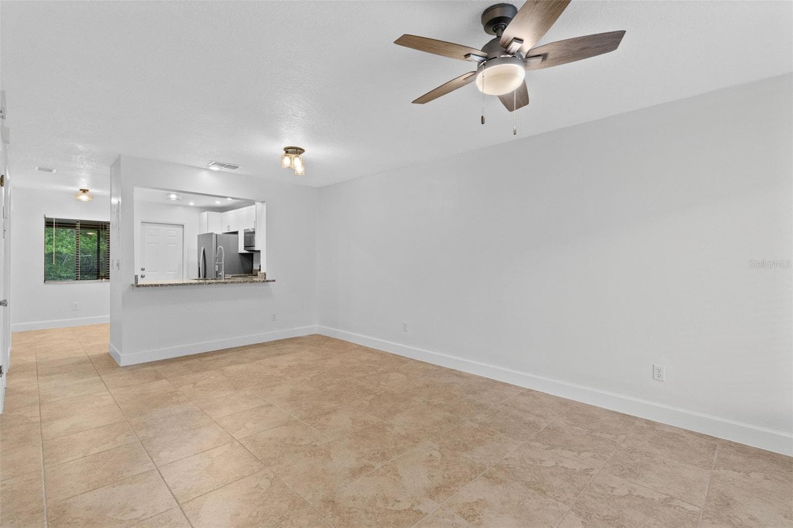 The main level features a spacious open living and dining area with plenty of room to create separate gathering and dining spaces while maintaining an easy flow throughout the home. - 283 SANDLEWOOD TRL #3, WINTER PARK