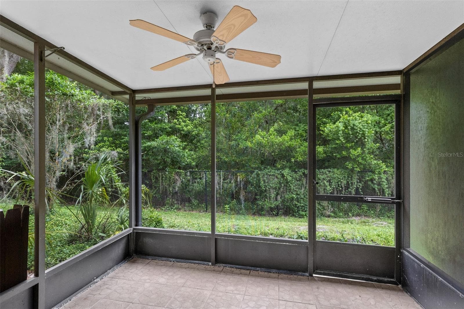Step outside to the private screened porch overlooking conservation, creating a peaceful outdoor space with added privacy and no rear neighbors directly behind you. - 283 SANDLEWOOD TRL #3, WINTER PARK