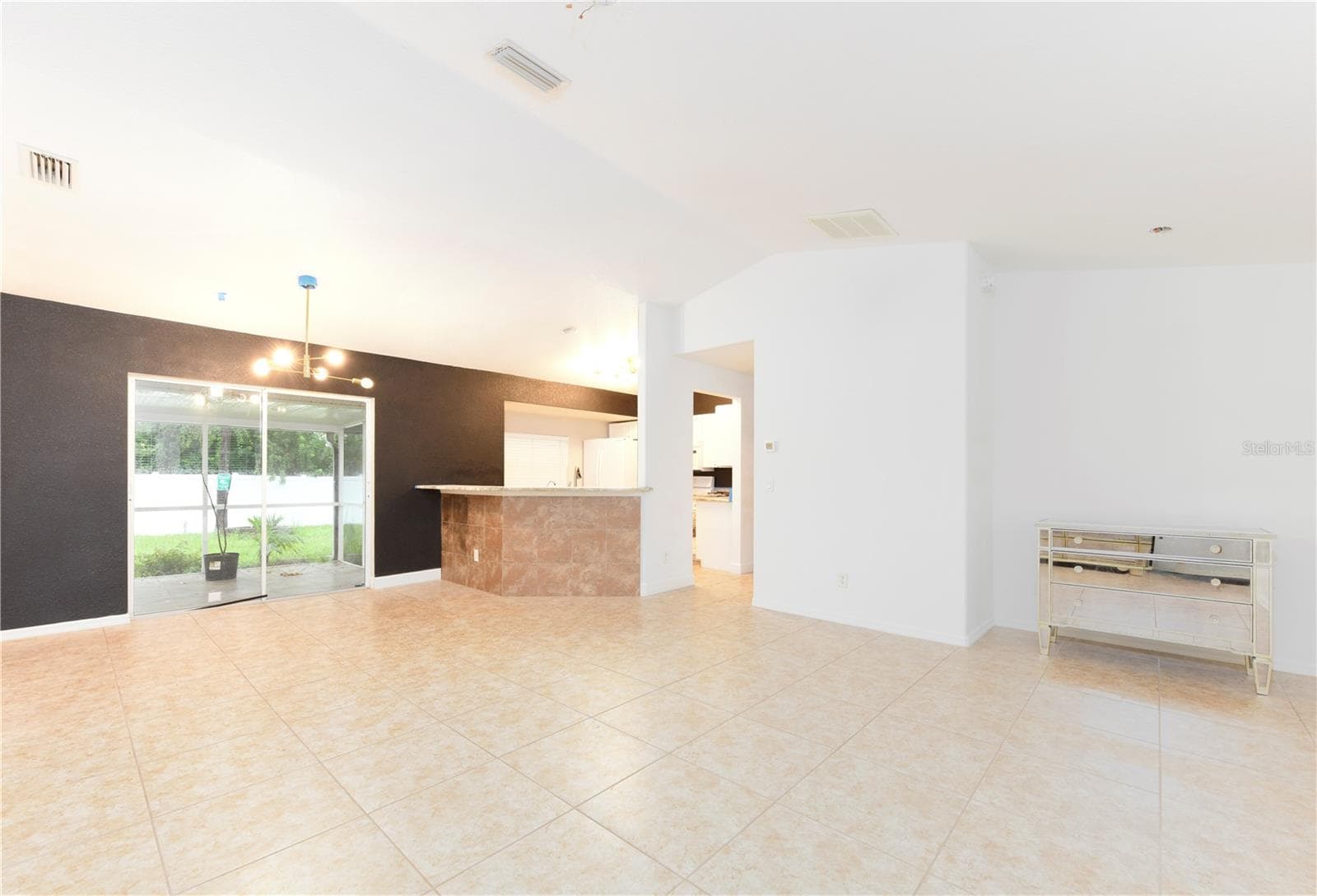 Living and dining room with vaulted ceiling - 8457 BRISTOL AVE, NORTH PORT