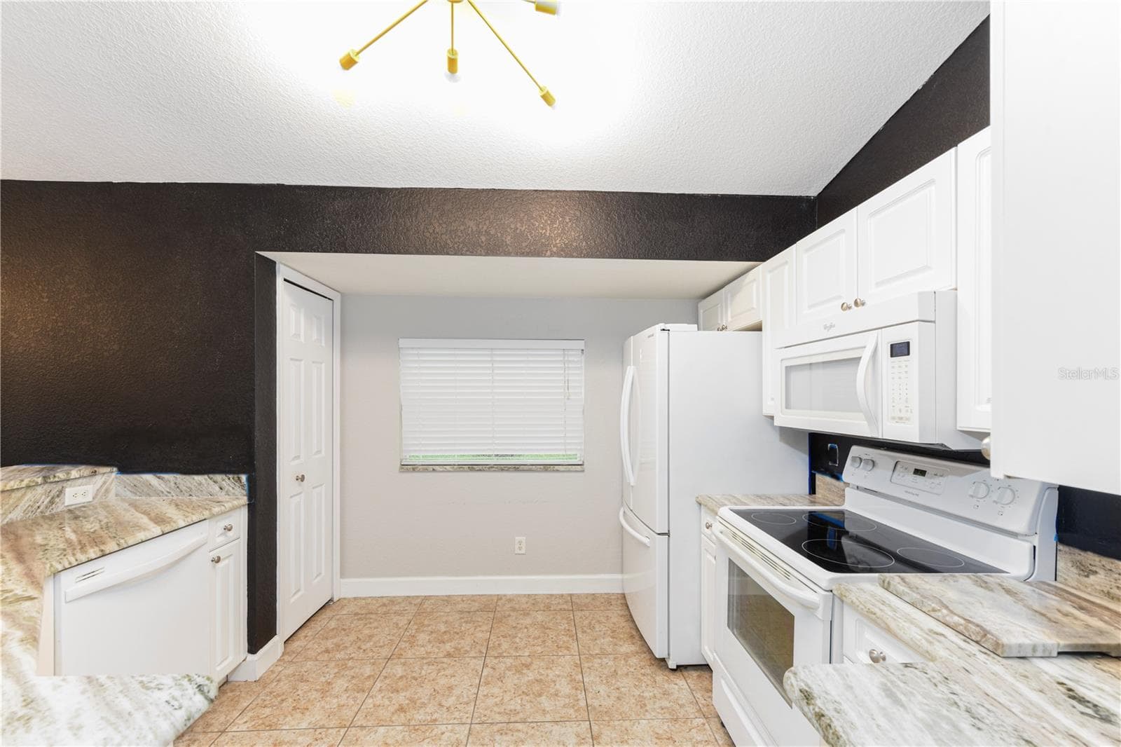 Kitchen with granite counter tops, dishwasher, French door fridge, range and built in microwave. - 8457 BRISTOL AVE, NORTH PORT