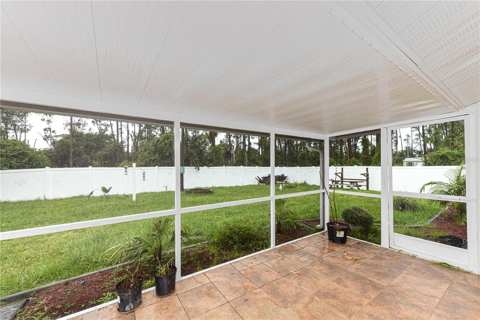Covered lanai with tile floor and large fenced yard. - 8457 BRISTOL AVE, NORTH PORT