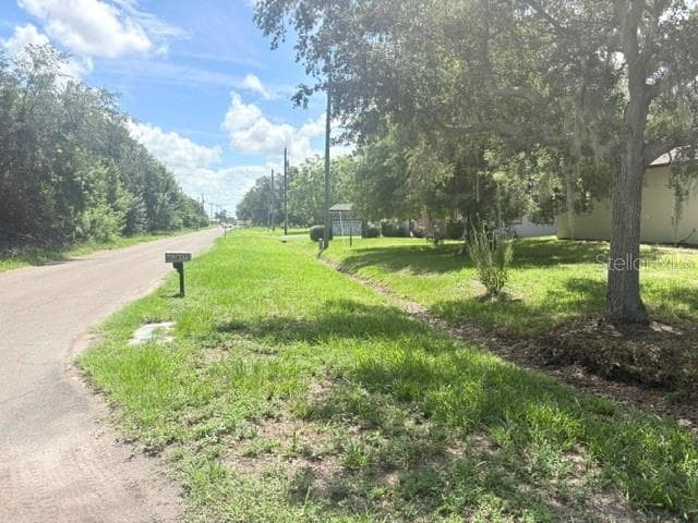 View from street with US 41 in distance. Corner lot and home. - 607 2ND ST NW, RUSKIN