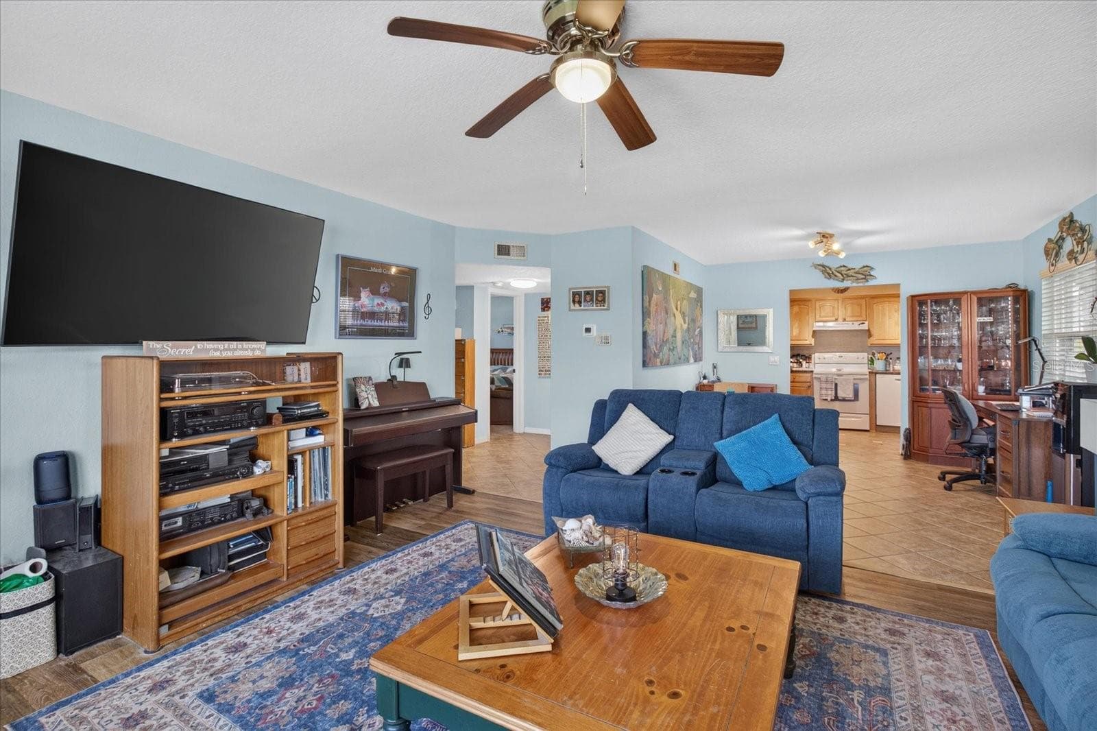 Living Room With Luxury Vinyl Plank and Impact Windows Installed in 2025. Open to the dining area and kitchen - 6100 GULFPORT BLVD S #401, GULFPORT