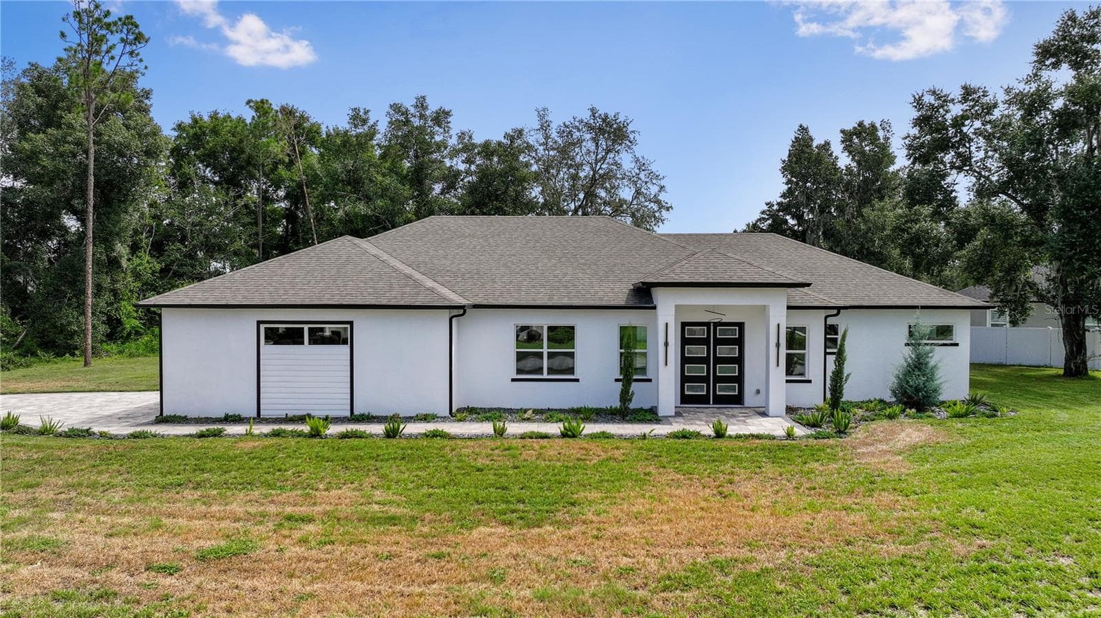 Impressive contemporary entrance featuring double doors and a welcoming paver walkway. - 9531 MID SUMMER LN, LEESBURG