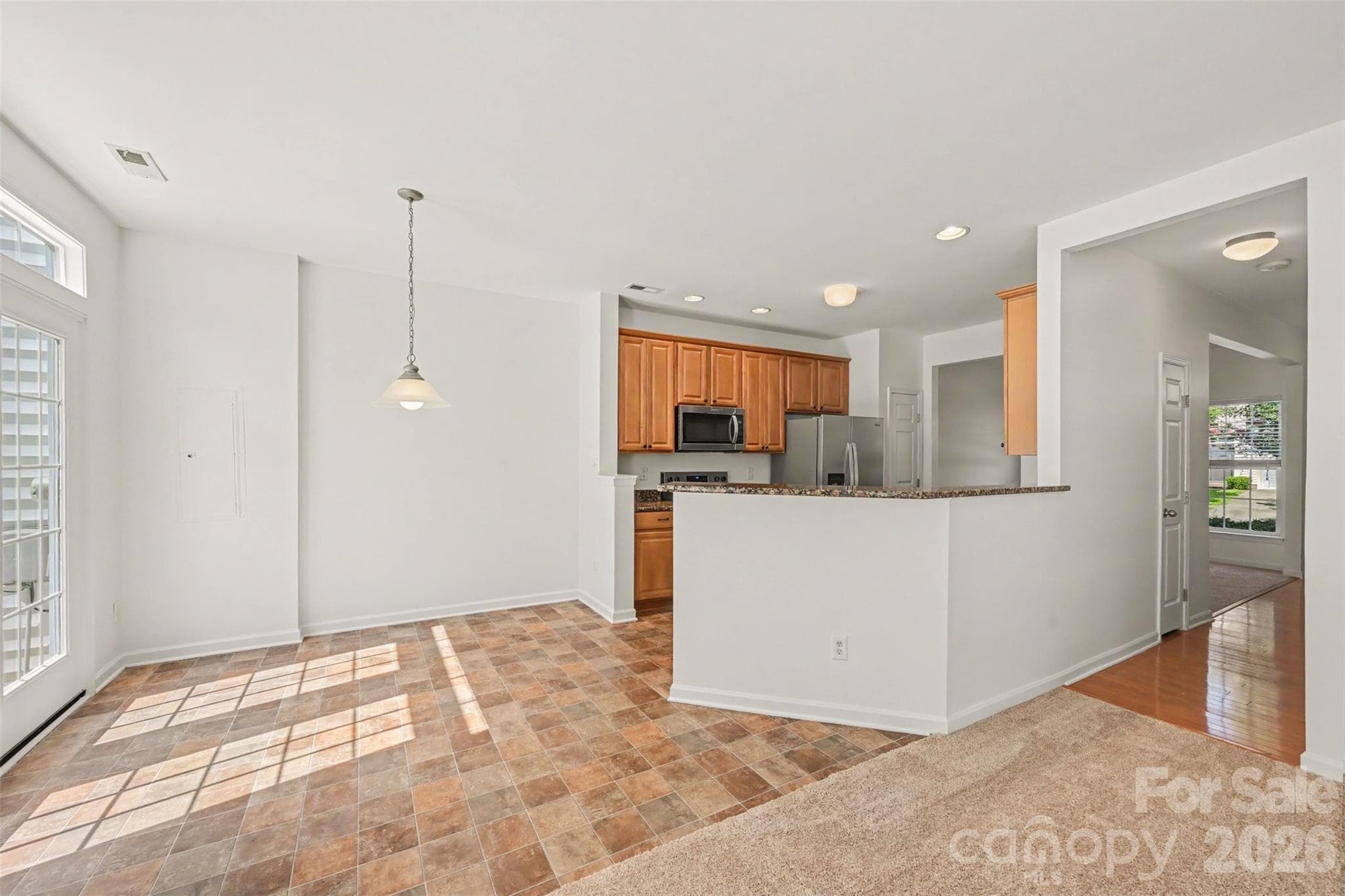 Well-lit breakfast area!  Enjoy beautiful view of tree-lined back yard from here. - Mooresville