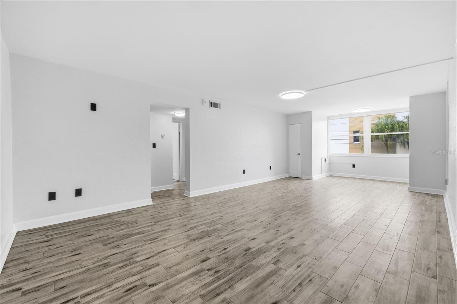 Step inside to a bright, freshly updated interior with new tile flooring and a spacious open living area. - 841 4TH AVE N #27, ST PETERSBURG