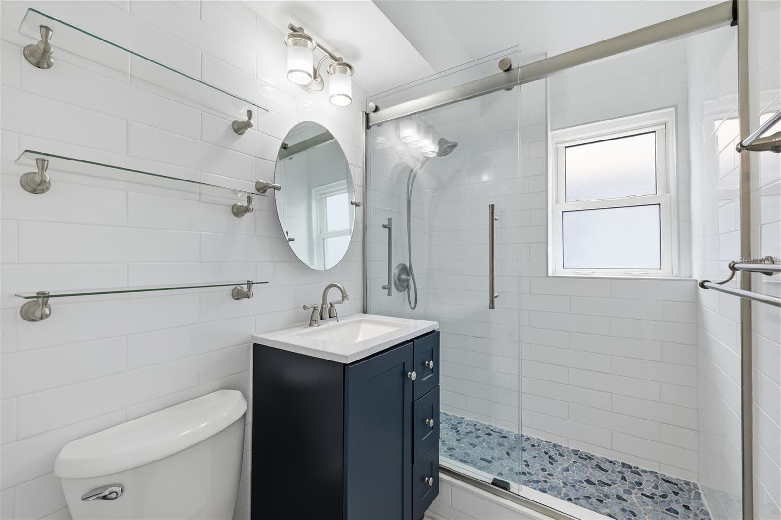 Fully updated bathroom with a fresh, modern design and beautifully finished shower. - 841 4TH AVE N #27, ST PETERSBURG