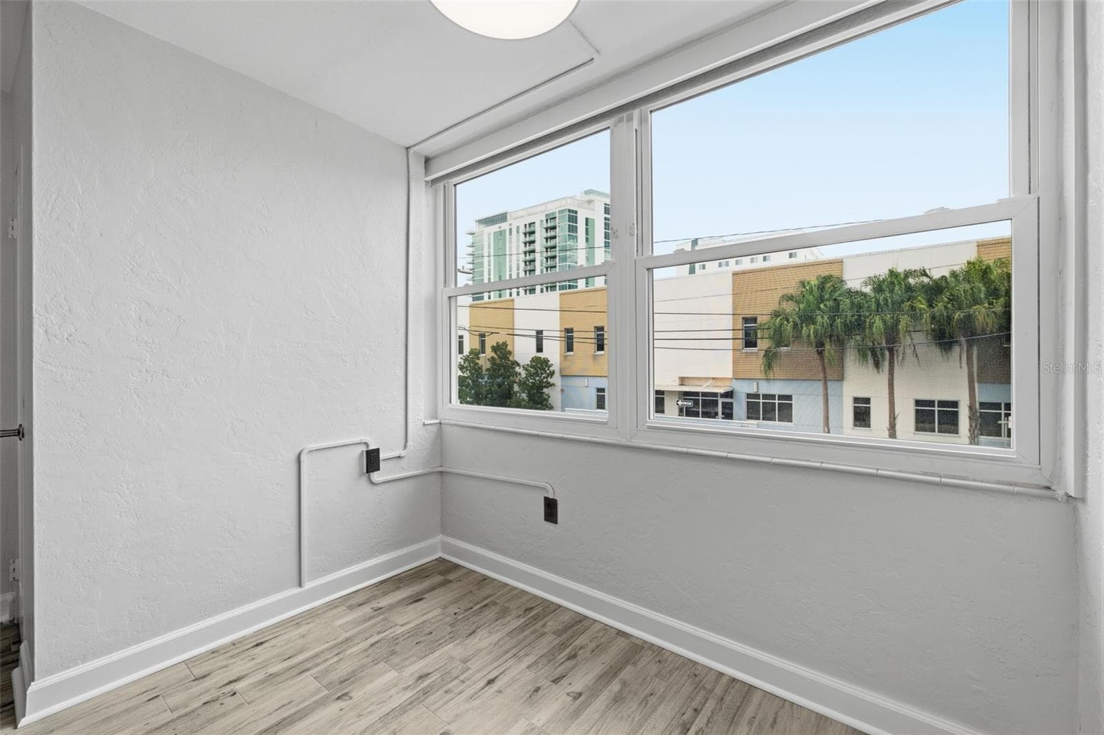 Natural light fills the living space through the new living room window, complete with convenient electric blinds. - 841 4TH AVE N #27, ST PETERSBURG