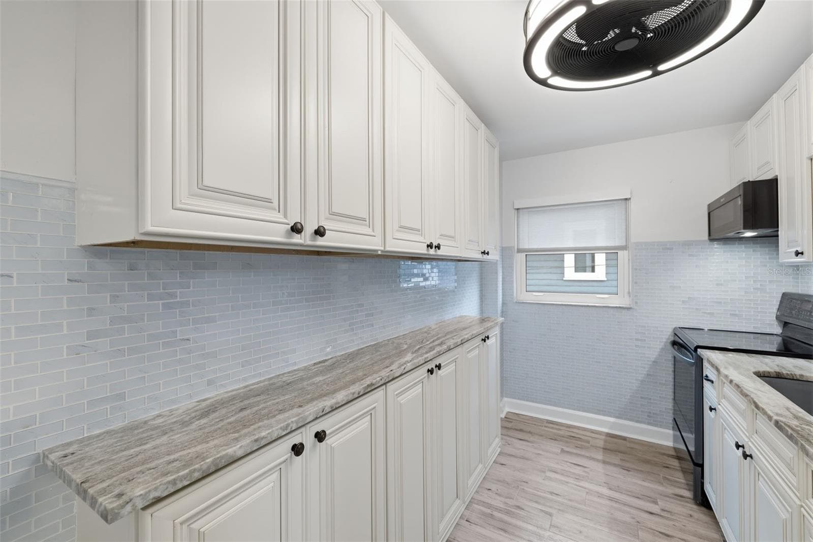 Bright, updated kitchen with abundant cabinetry and counter space for everyday cooking and storage. - 841 4TH AVE N #27, ST PETERSBURG