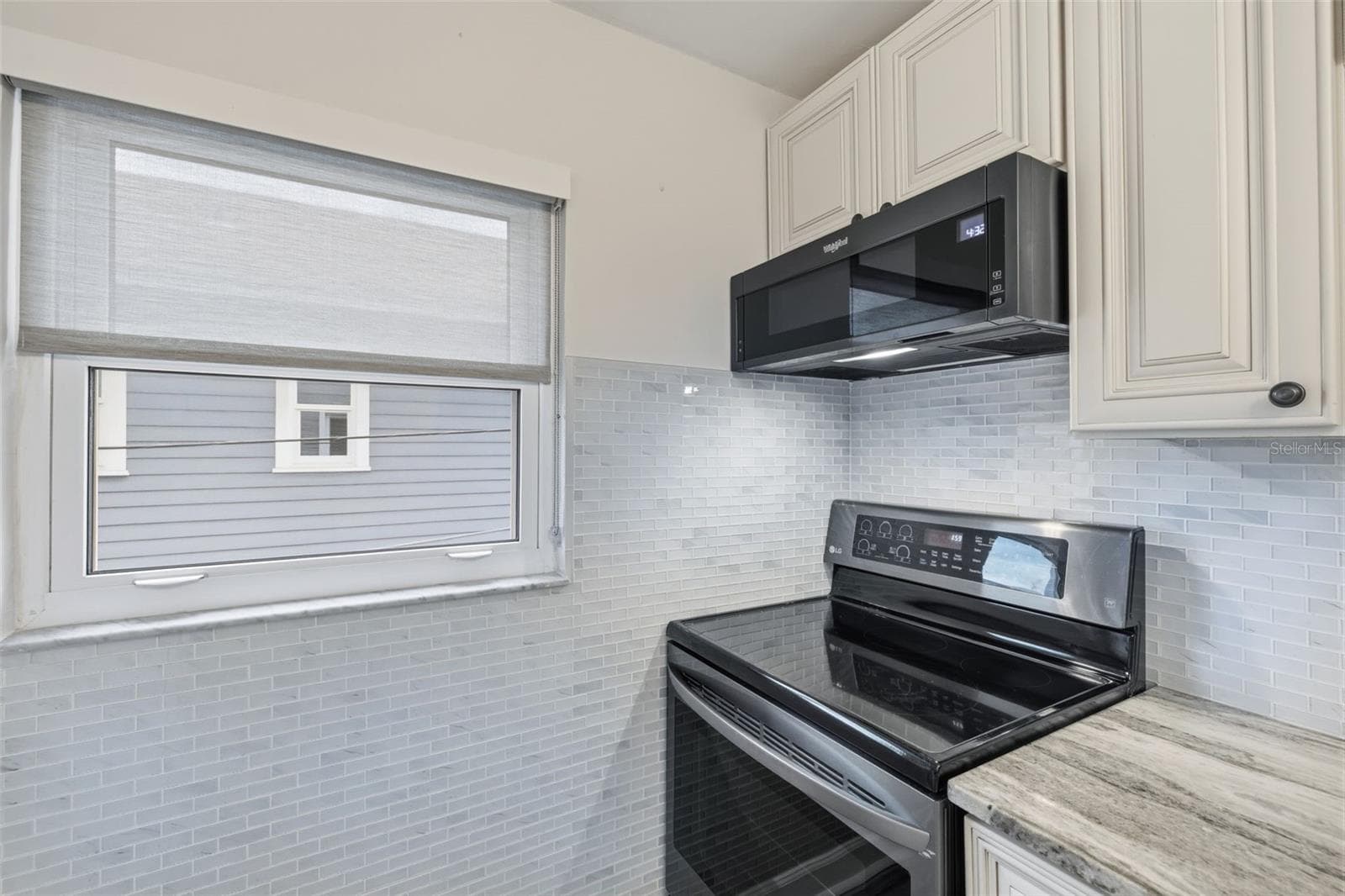 A functional kitchen layout offers generous cabinetry, counter space, and newer finishes. - 841 4TH AVE N #27, ST PETERSBURG