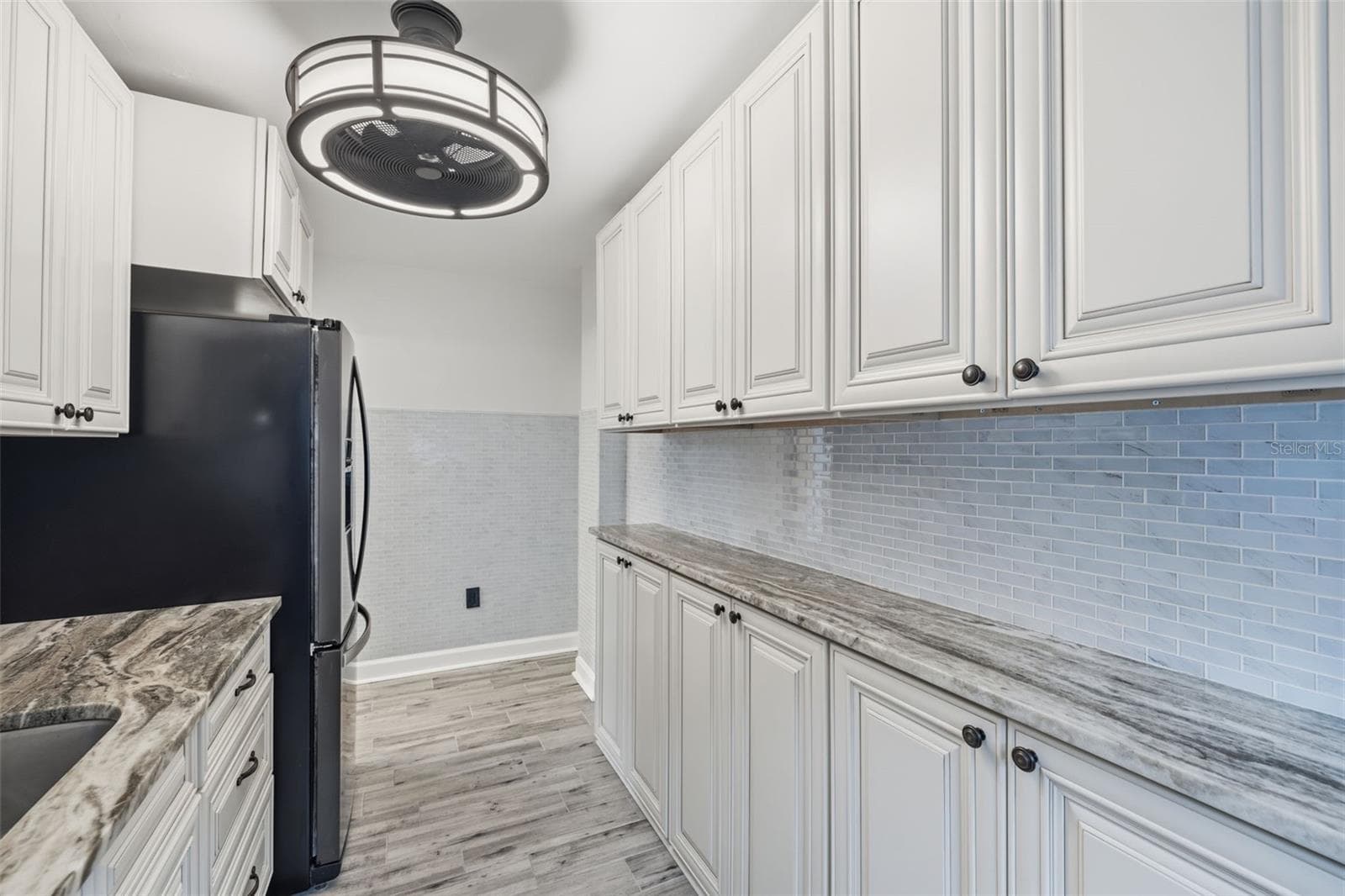 Another view of the kitchen showcasing the ample cabinet storage and counter space. - 841 4TH AVE N #27, ST PETERSBURG