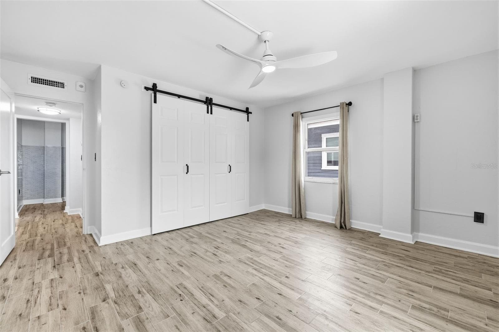 Bright primary bedroom with plenty of space for a full bedroom suite and additional furnishings. - 841 4TH AVE N #27, ST PETERSBURG