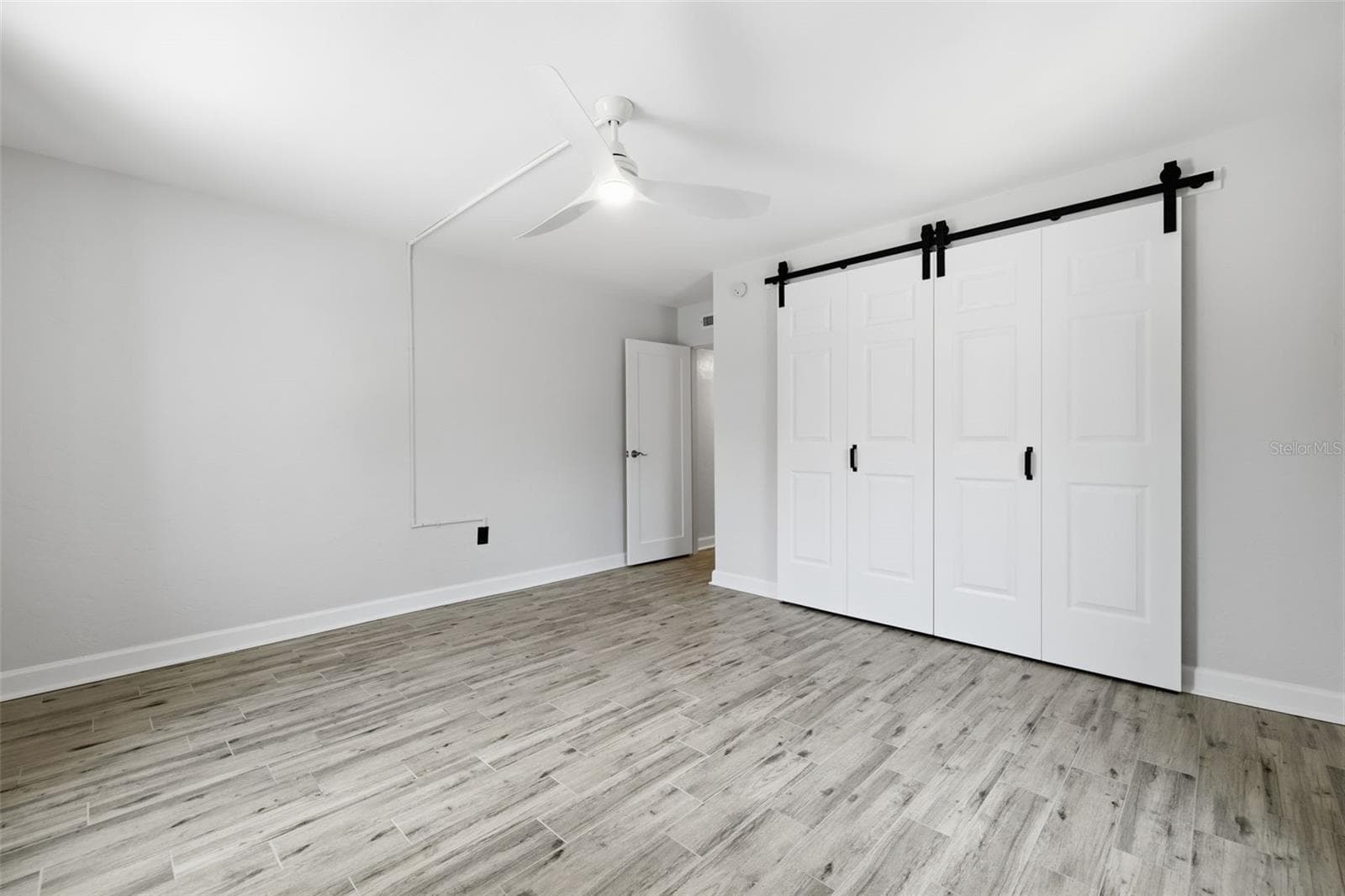 The primary bedroom includes a generously sized closet with an updated sliding door. - 841 4TH AVE N #27, ST PETERSBURG
