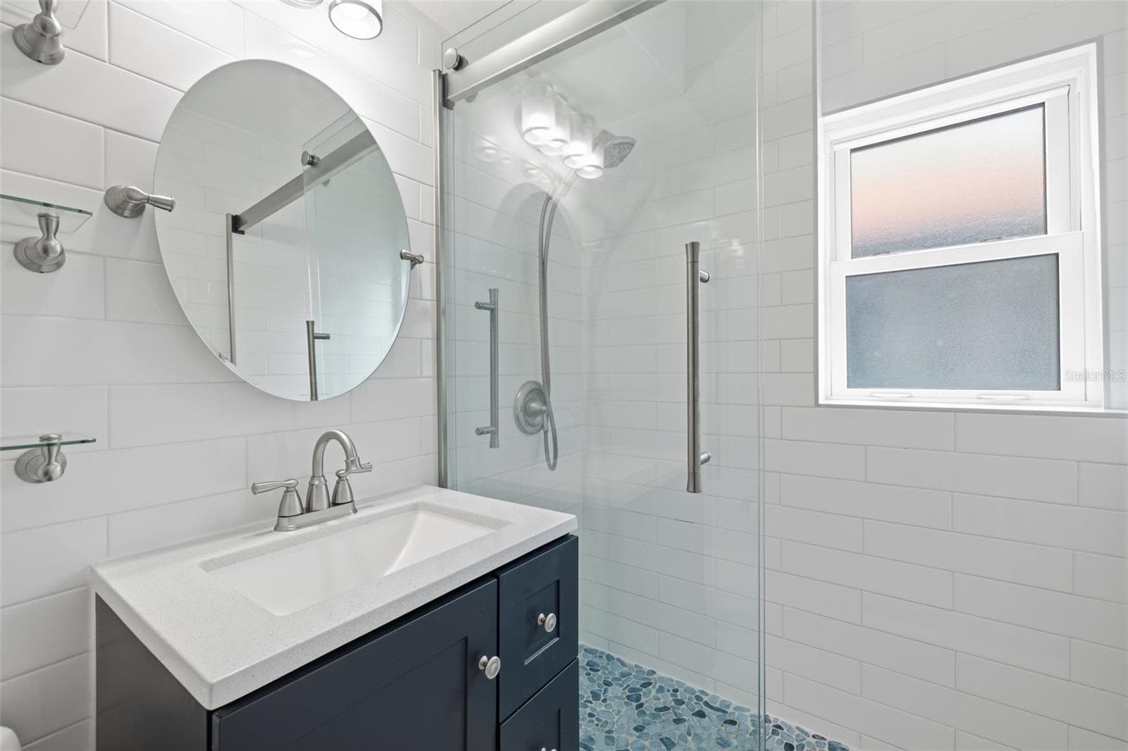 Updated vanity, contemporary fixtures, and a bright window complete the refreshed bathroom. - 841 4TH AVE N #27, ST PETERSBURG