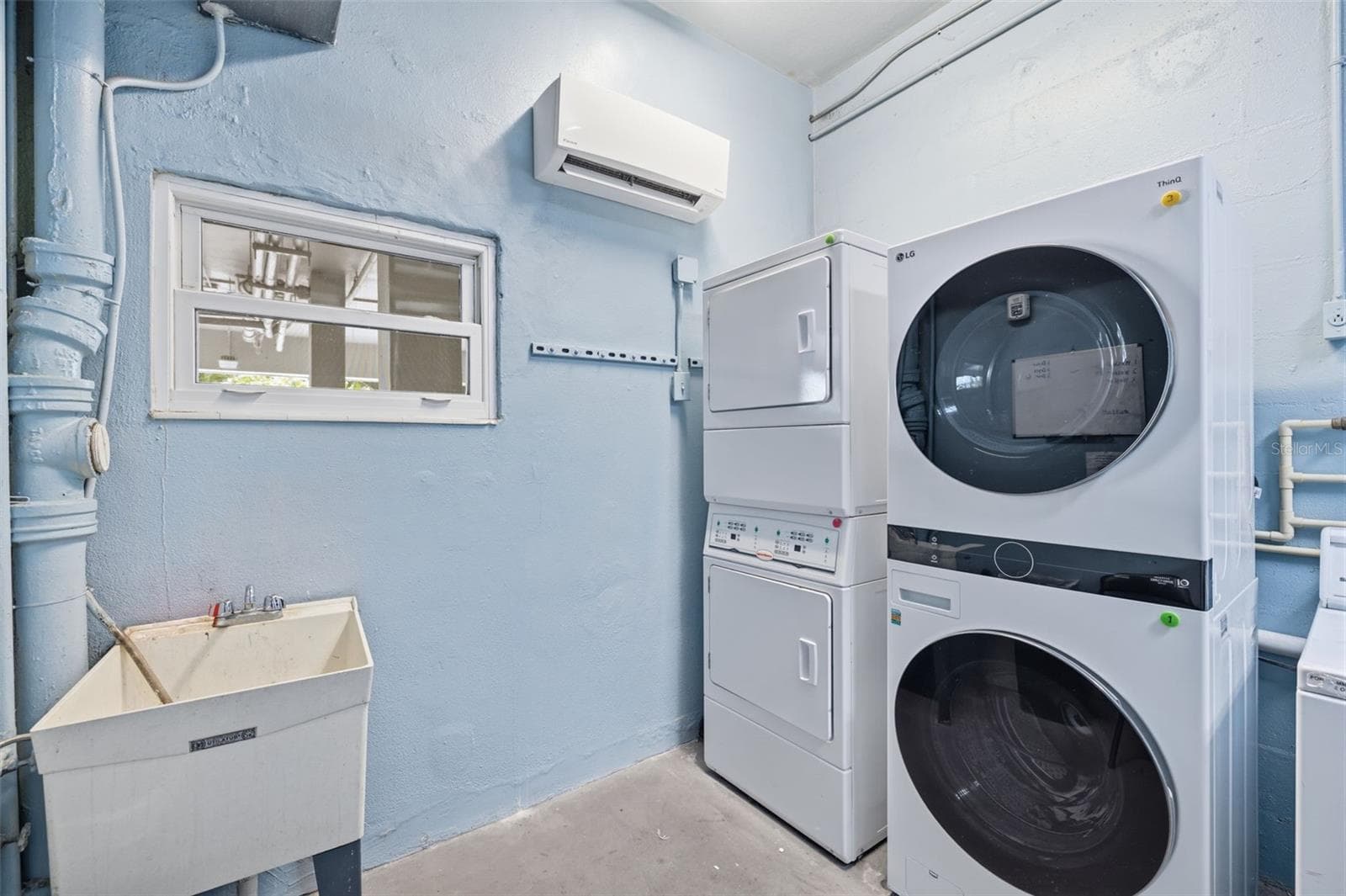 Updated community laundry facilities feature newer equipment for residents’ convenience. - 841 4TH AVE N #27, ST PETERSBURG