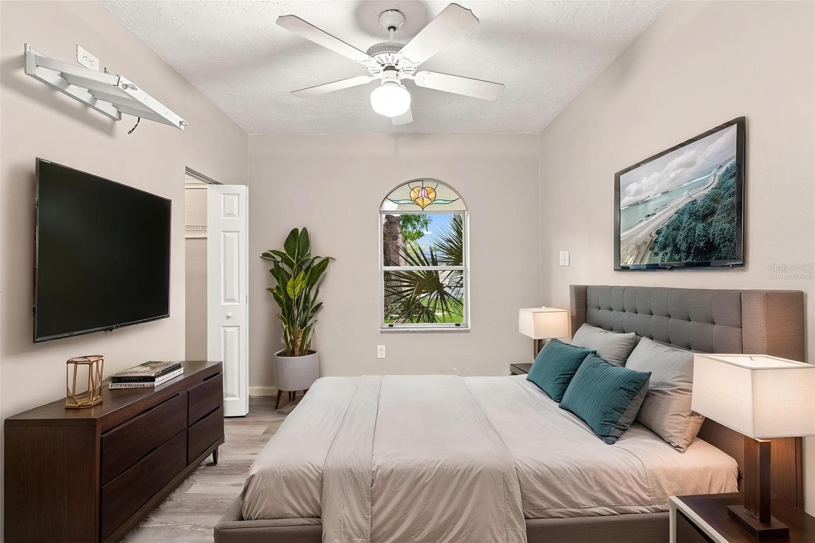 Virtually Staged Inviting Primary Bedroom with Vaulted Ceiling and and Stained Glass Window - 1005 ALSTON LN, ENGLEWOOD