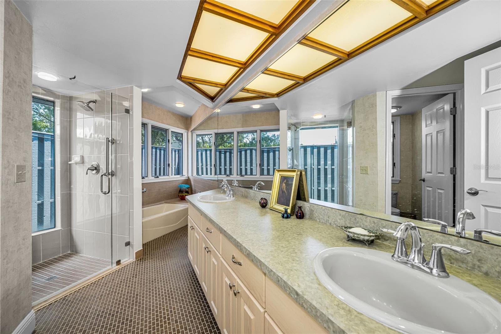 Master bath with tub and shower and double vanity and custom cabinets - 10479 LONGWOOD DR, SEMINOLE