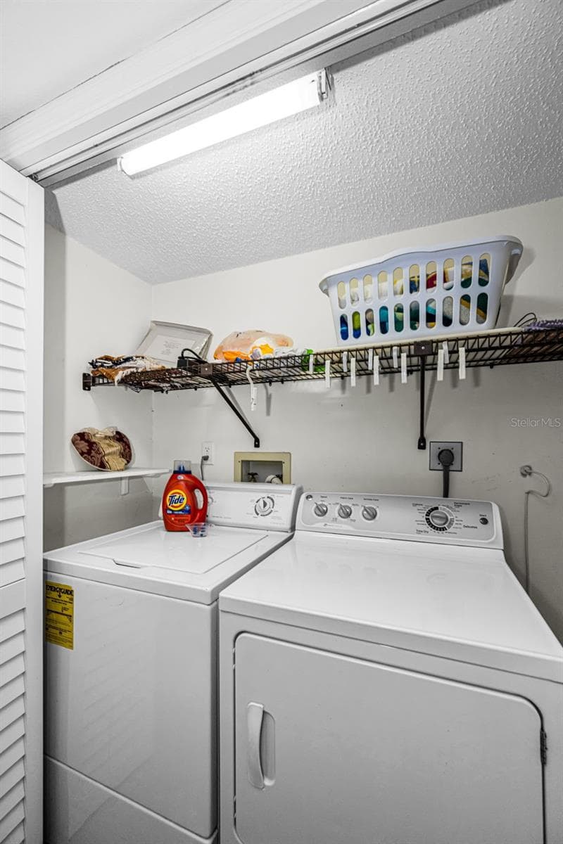 Inside laundry closet near bedrooms 2 and 3. - 10479 LONGWOOD DR, SEMINOLE