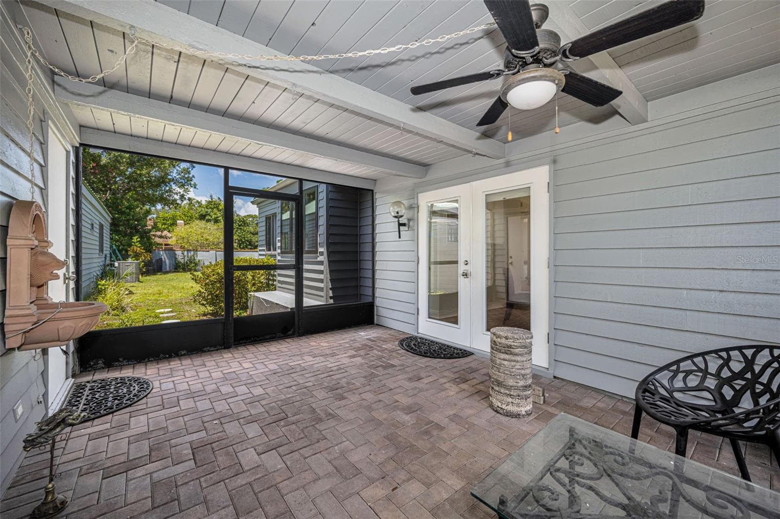 Breezeway between the home and the two car garage. This opens to the back yard! - 10479 LONGWOOD DR, SEMINOLE