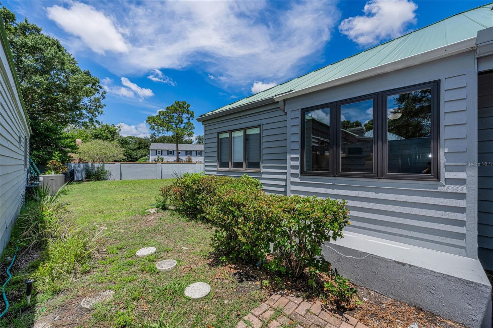Walking from the breezeway to the back yard. - 10479 LONGWOOD DR, SEMINOLE