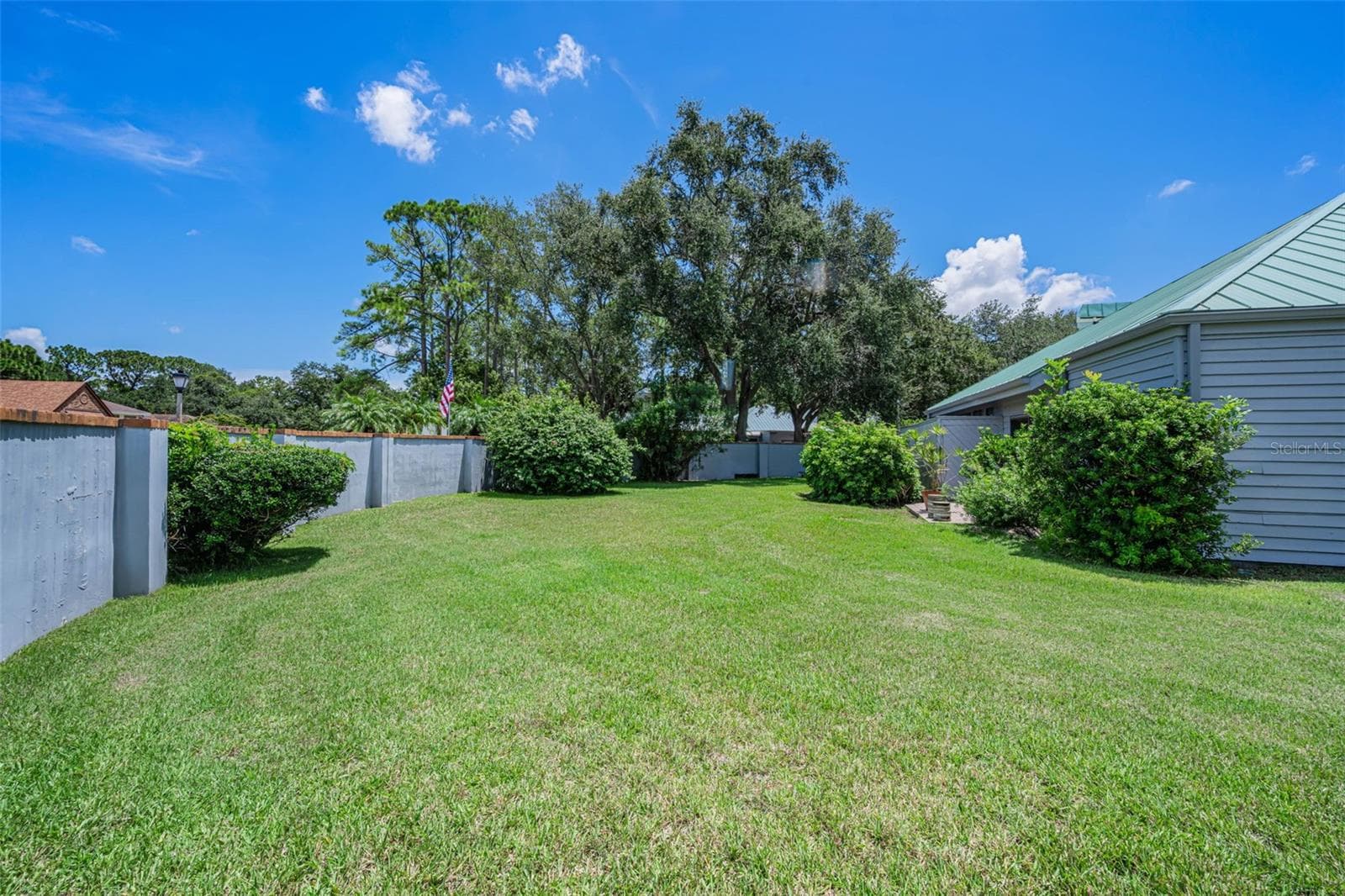 Backyard is wrapped by the wall and would give privacy to the pool! - 10479 LONGWOOD DR, SEMINOLE