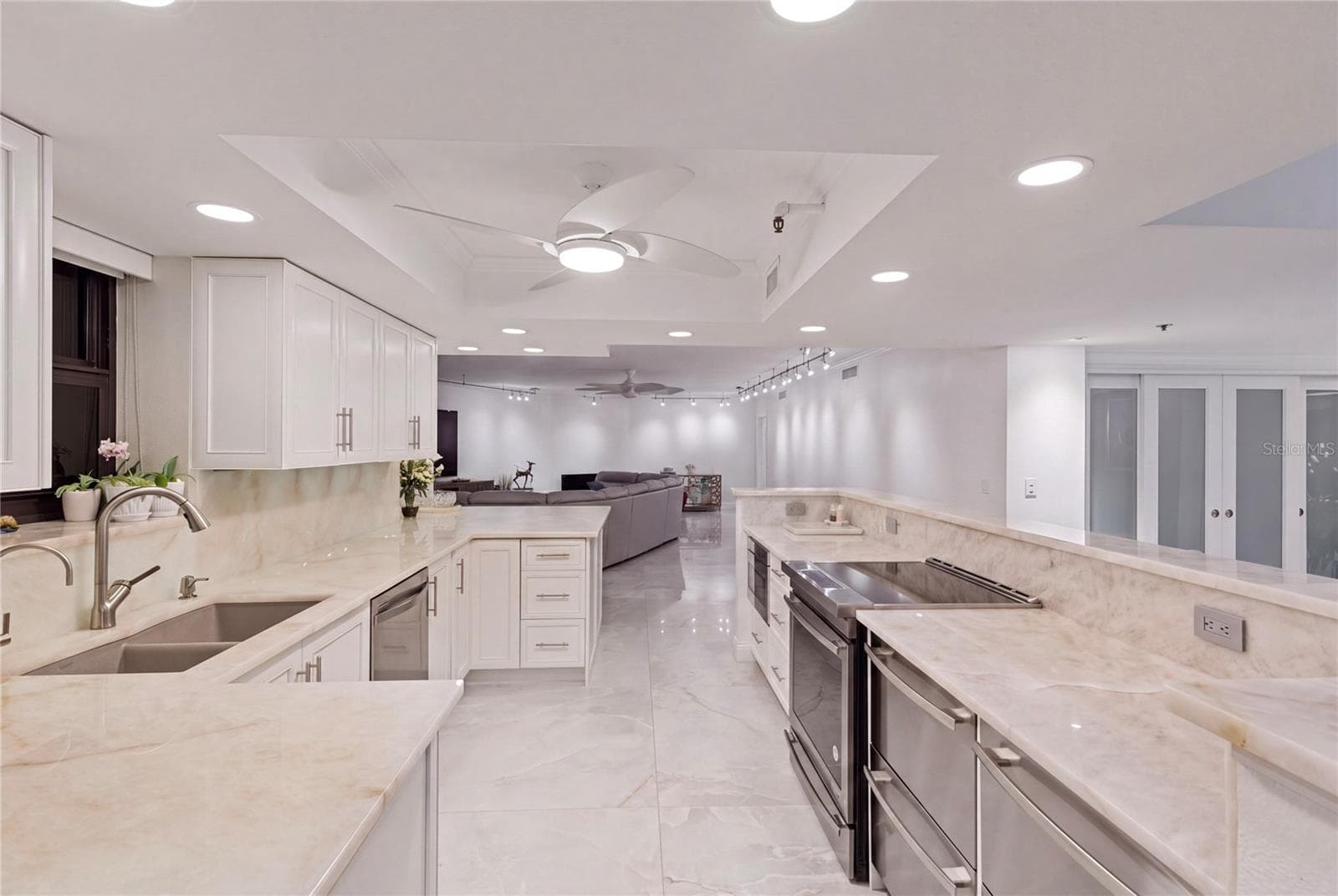 A view of the kitchen from the coffee area looking into the great room. - 1660 GULF BLVD #PH1, CLEARWATER BEACH