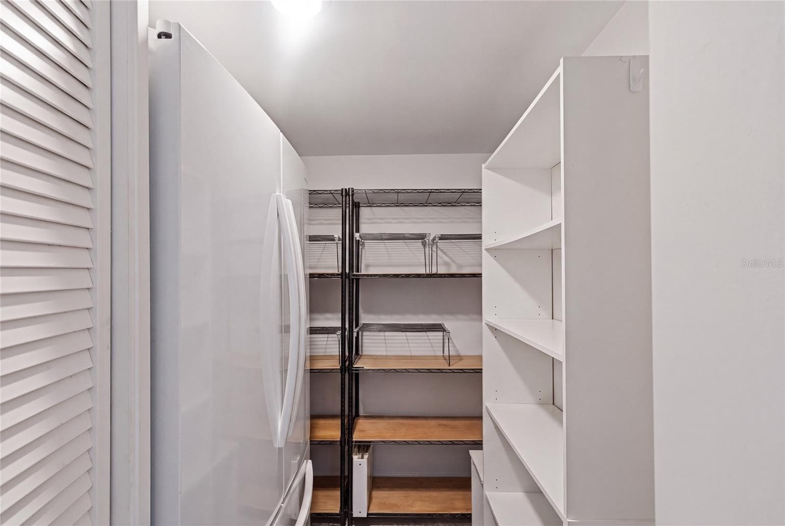 Butler's pantry with an extra fridge and storage galore! - 1660 GULF BLVD #PH1, CLEARWATER BEACH