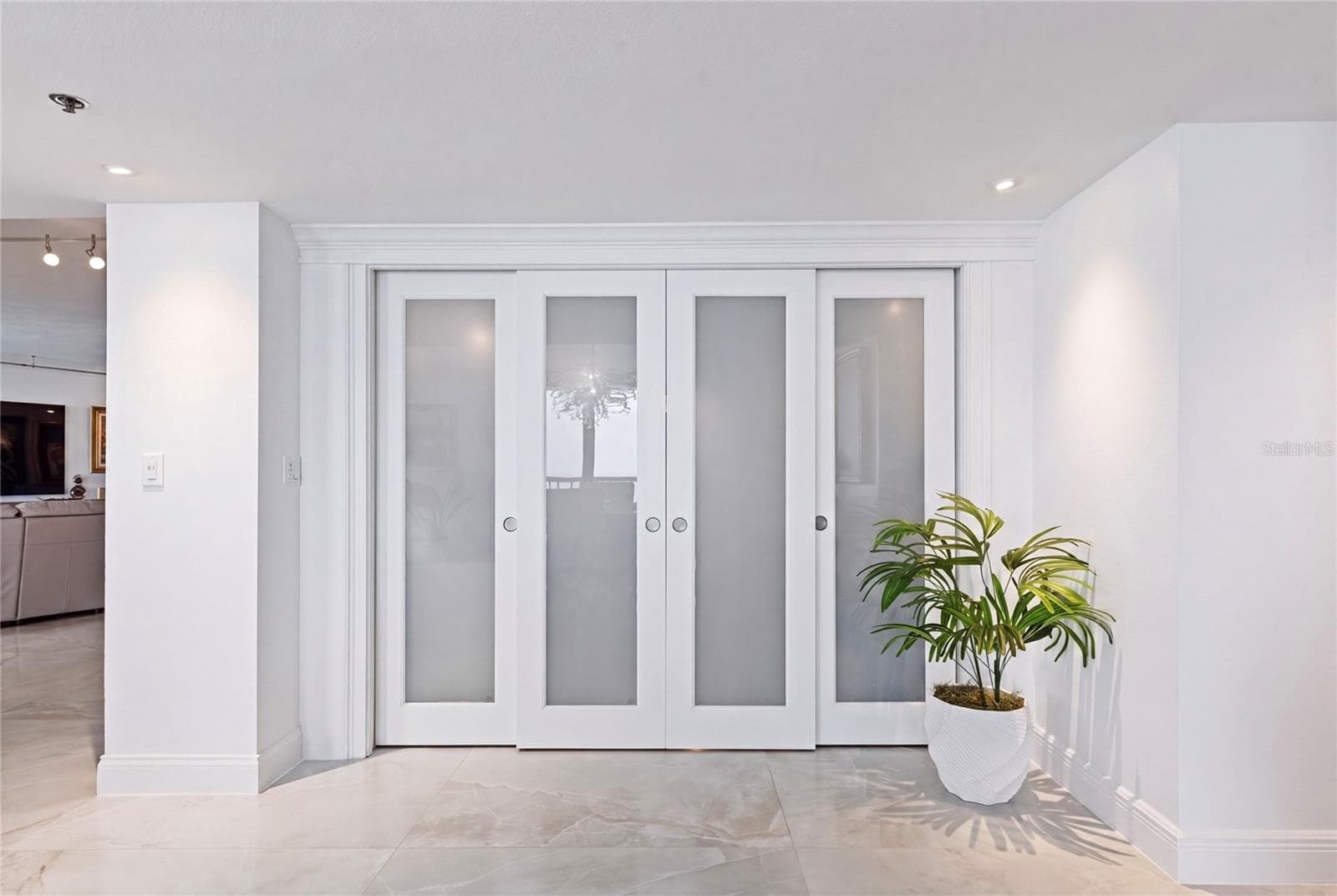 The sitting room/ bonus room/office or 4th bedroom are right through these doors. - 1660 GULF BLVD #PH1, CLEARWATER BEACH