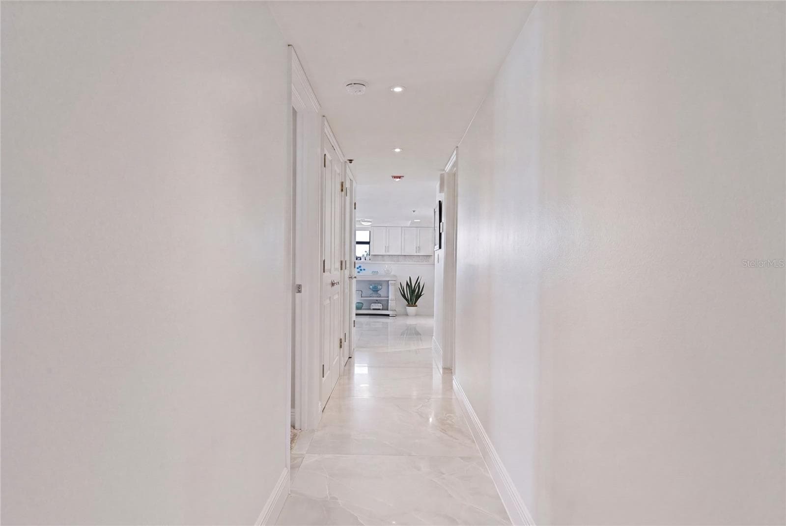 A private hallway leads to the Primary Suite. - 1660 GULF BLVD #PH1, CLEARWATER BEACH