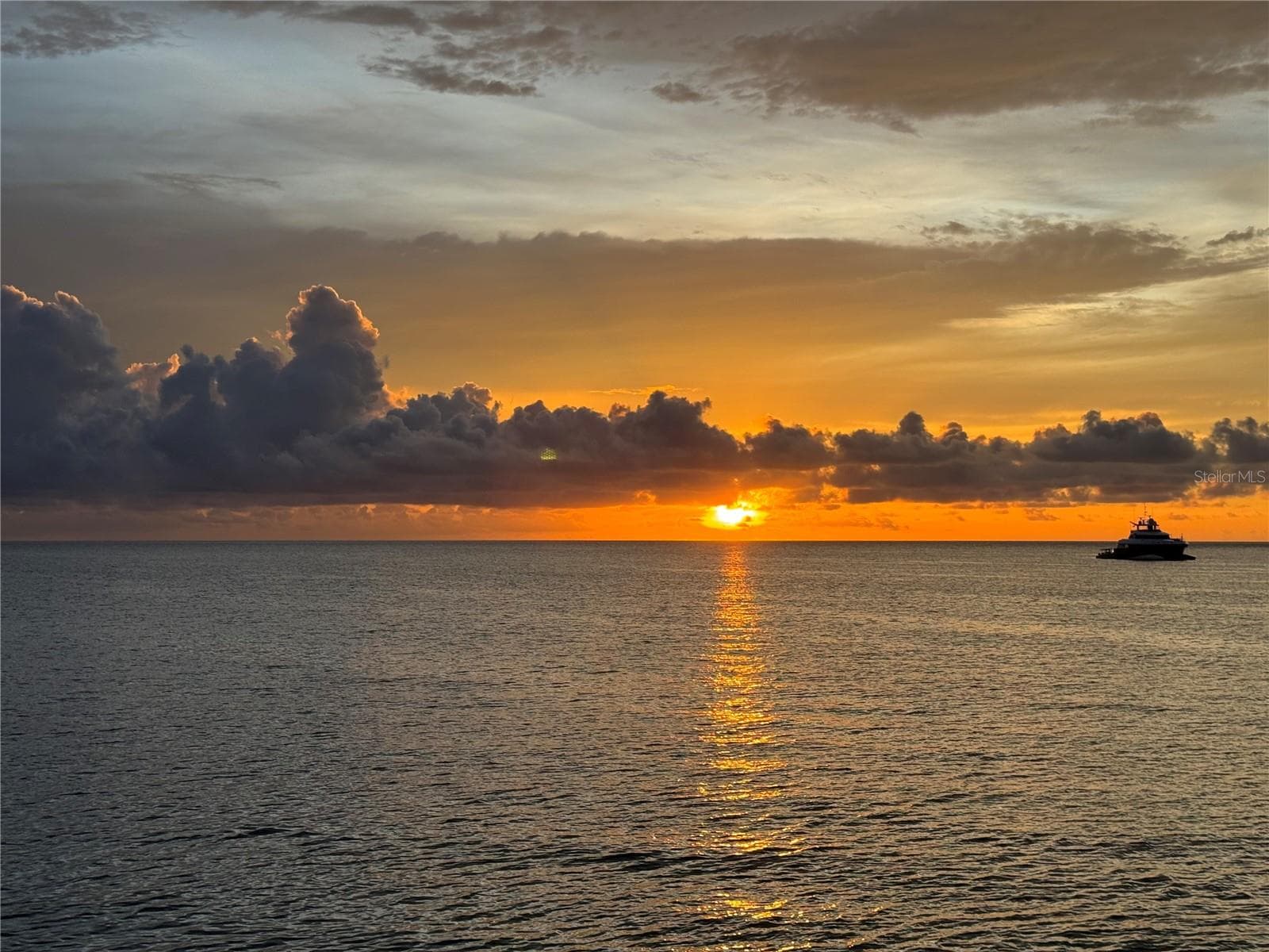 The sky turns to molten gold over the calm waters. - 1660 GULF BLVD #PH1, CLEARWATER BEACH