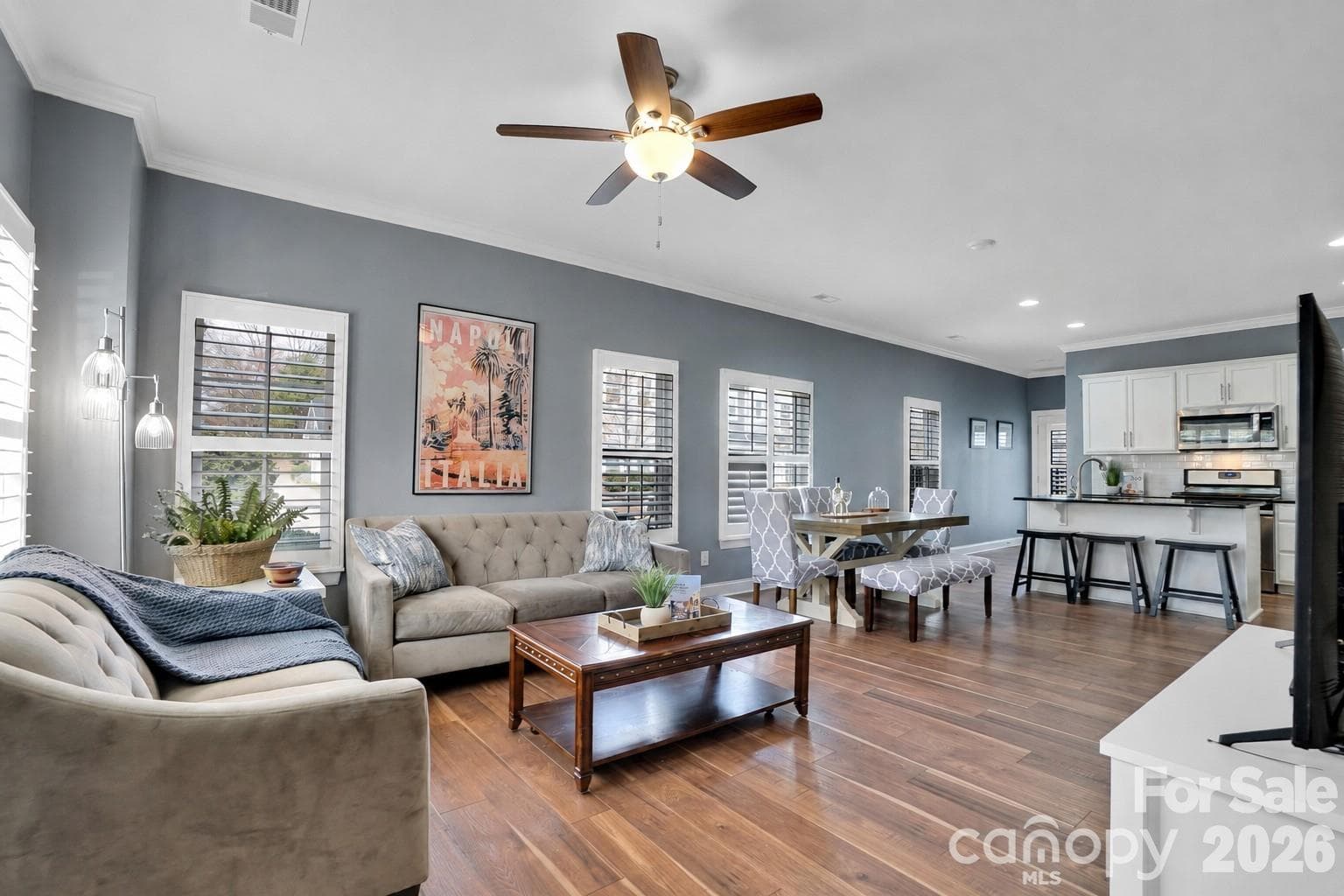 Open concept living room, dining and kitchen complete. Lots of windows with plantation shutters throughout! - 1178 Almerton Drive, Denver