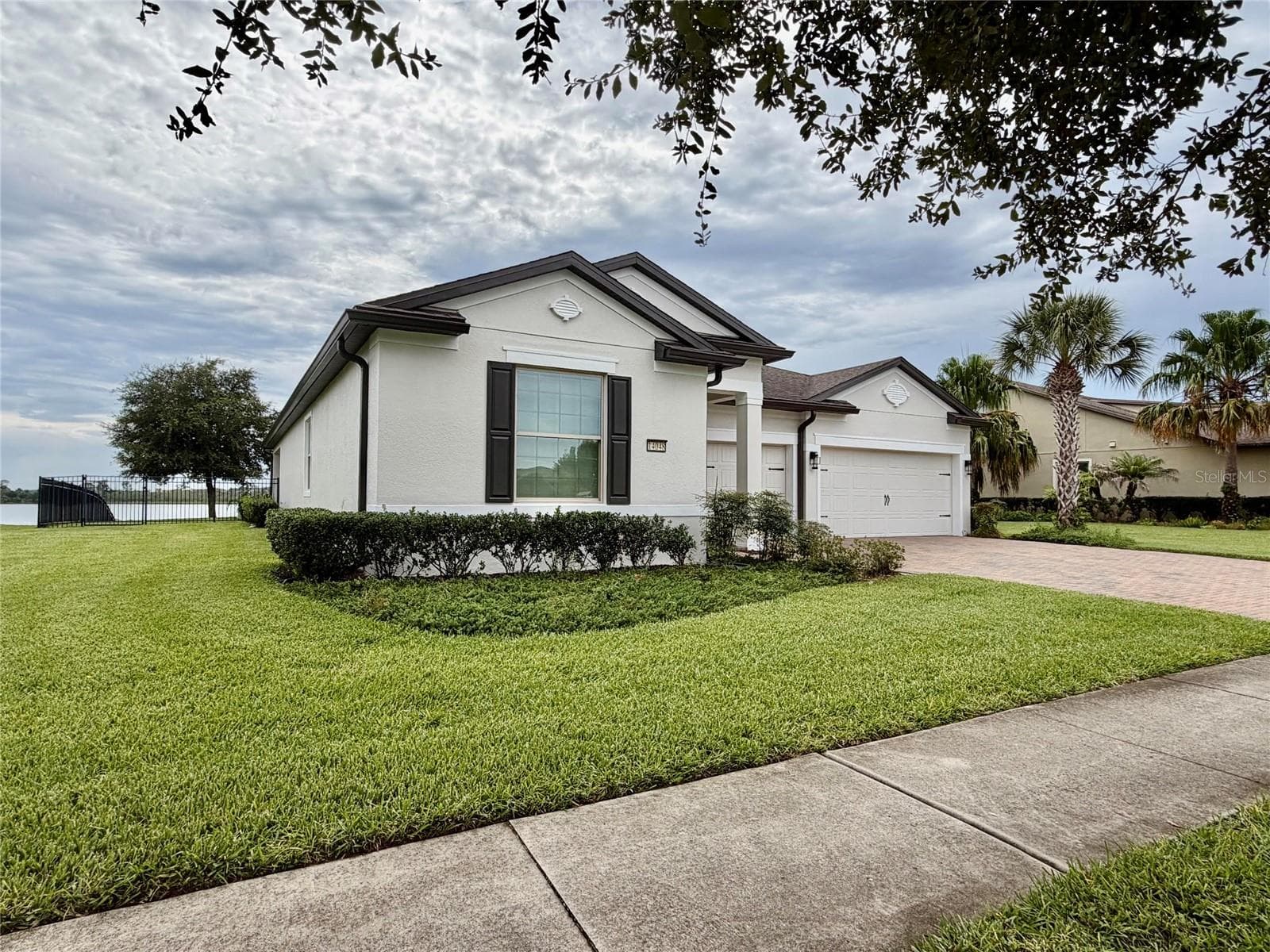 14048 Larkspur Lake Dr - Side exterior showcasing the home's single-story design and generous lot. - 14048 LARKSPUR LAKE DR, WINTER GARDEN