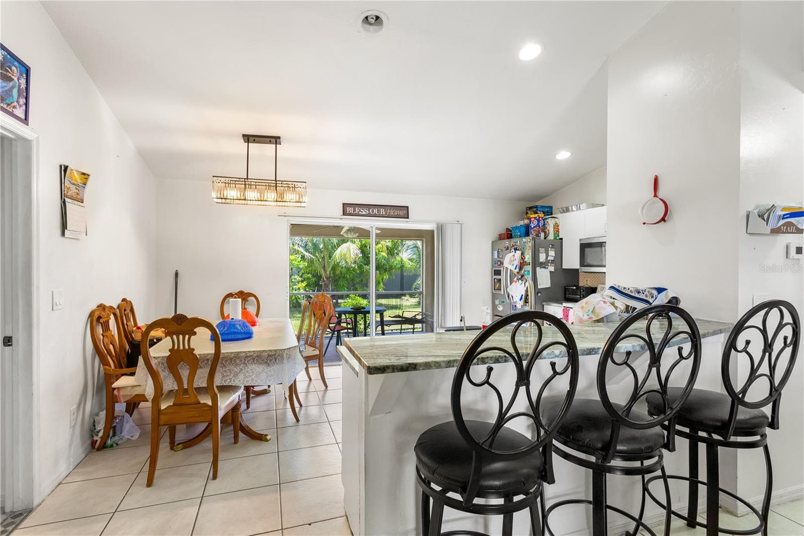 The SPACIOUS KITCHEN is designed with function and style in mind, offering plenty of GRANITE COUNTER SPACE, cabinets, a pantry - 1728 NE 22ND TER, CAPE CORAL