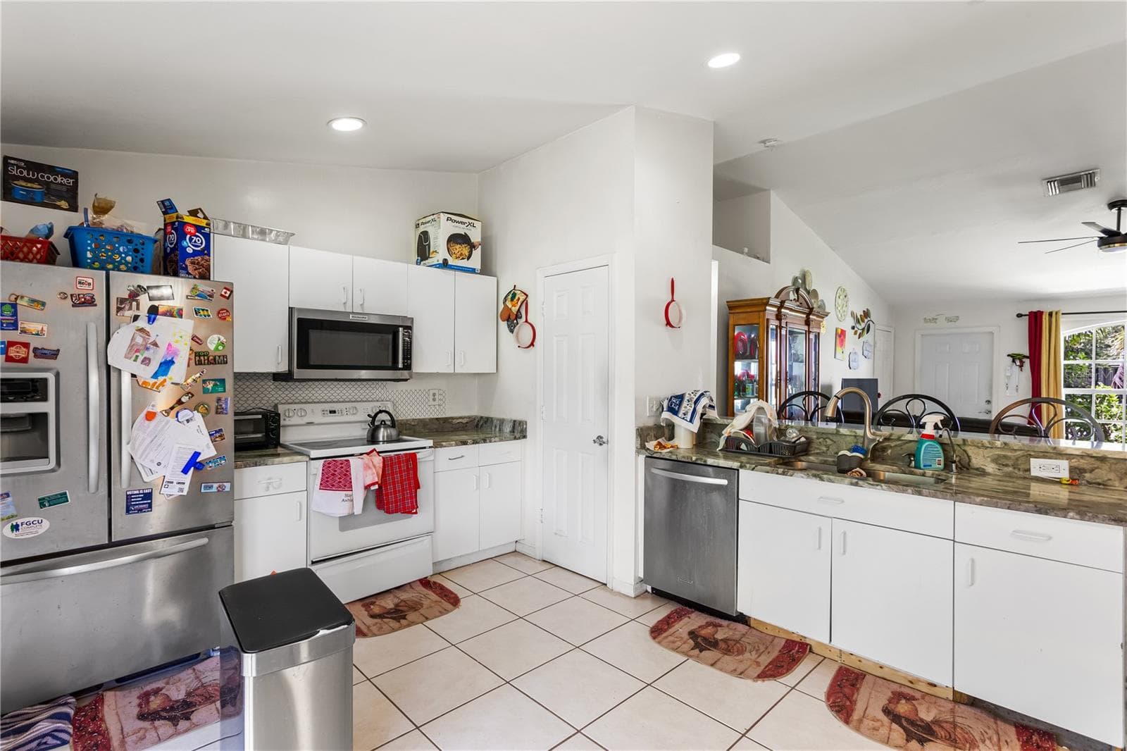 NEWER STAINLESS-STEEL APPLIANCES including a large refrigerator/freezer, microwave, and dishwasher - 1728 NE 22ND TER, CAPE CORAL