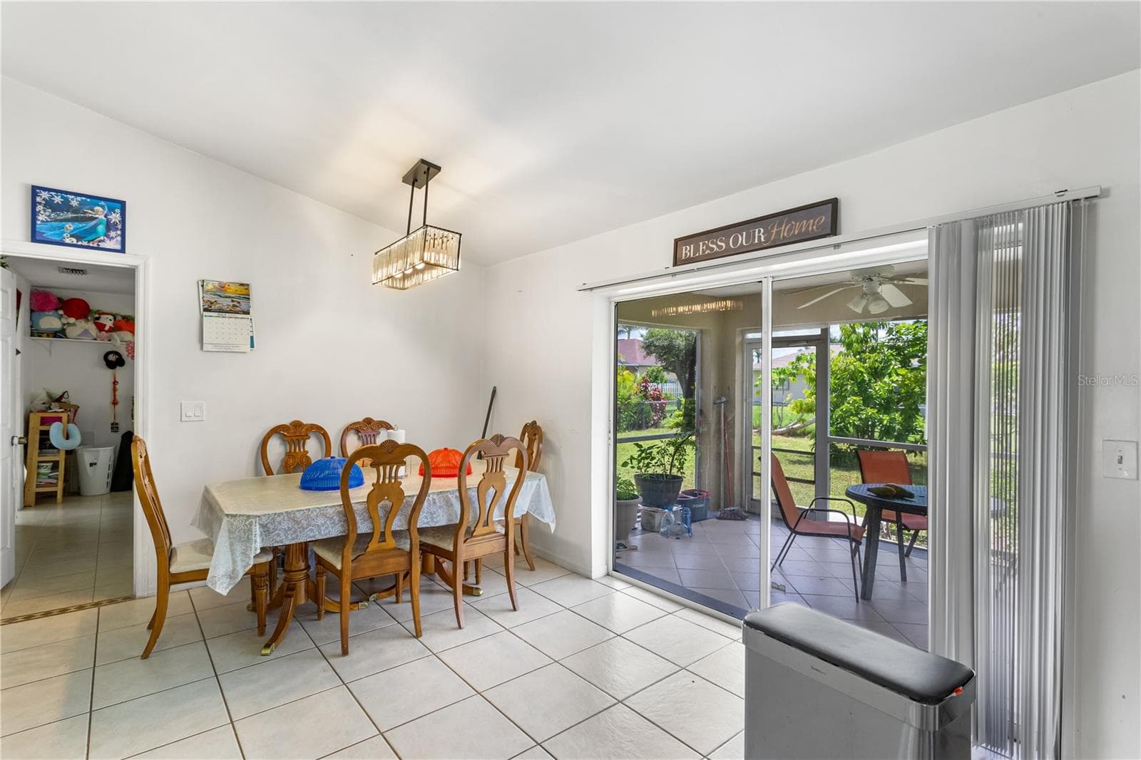 The L-shaped layout flows into a dining area and breakfast bar, making this an ideal space for EVERYDAY LIVING or ENTERTAINING - 1728 NE 22ND TER, CAPE CORAL