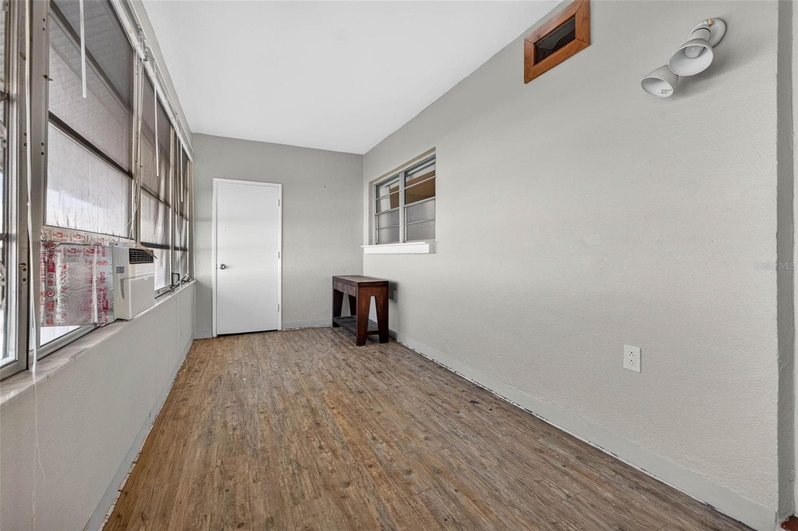Spacious enclosed Florida room ideal for a sitting area, office, or flex space. - 6015 19TH ST N #215, ST PETERSBURG