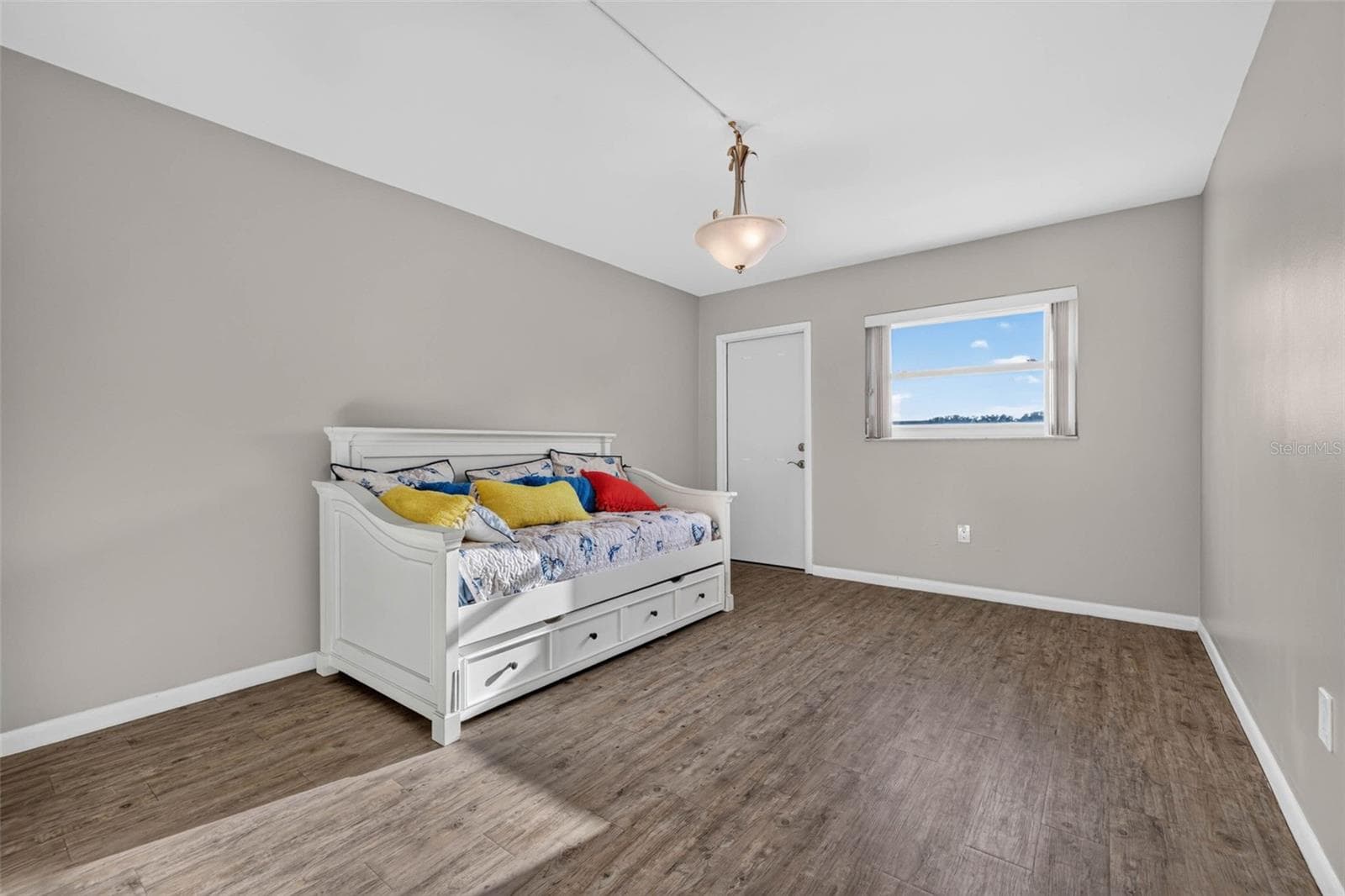 Large secondary bedroom with modern flooring and ample space for comfortable living. - 6015 19TH ST N #215, ST PETERSBURG