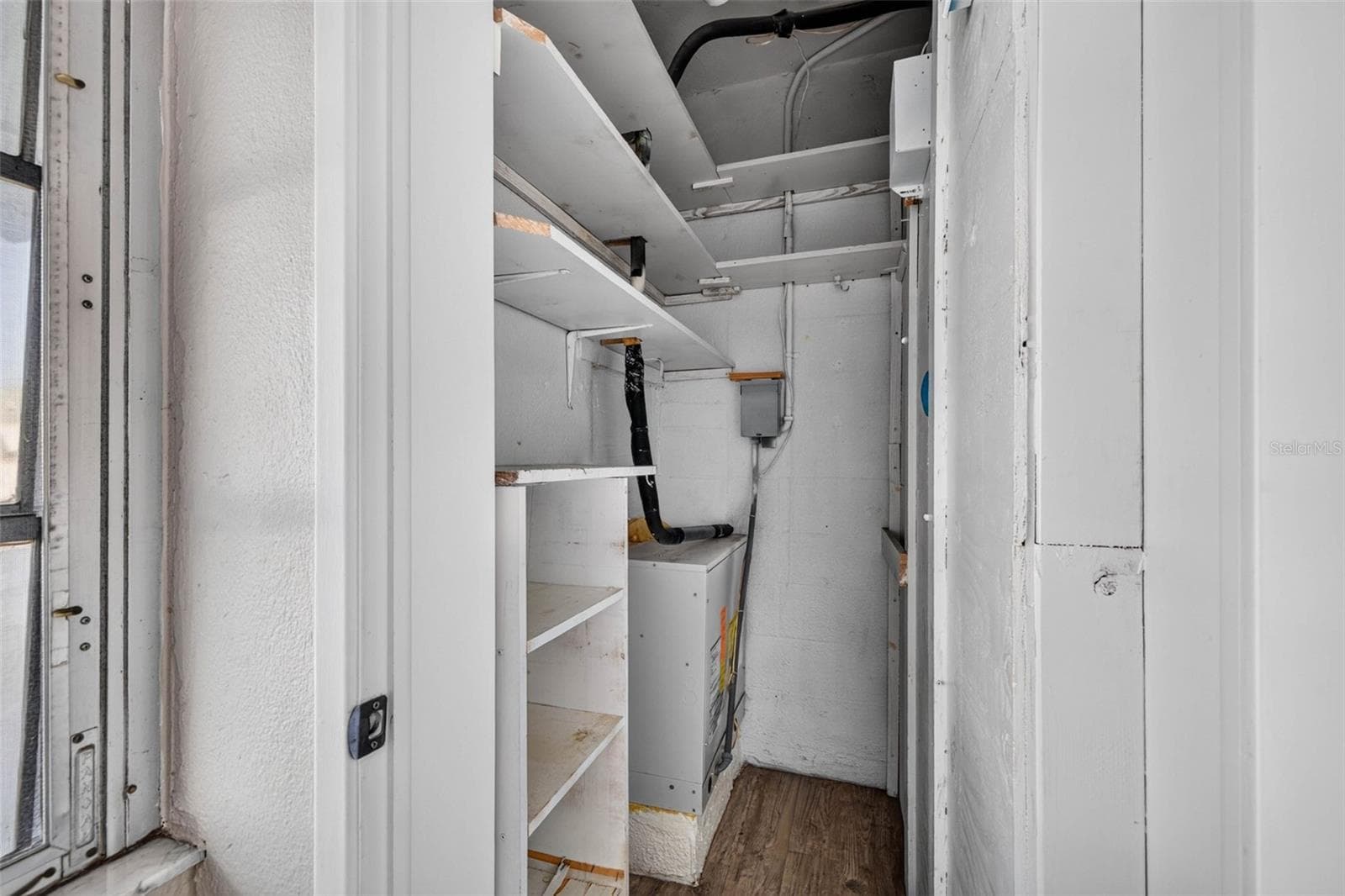 Dedicated storage closet with built-in shelving and mechanical systems. - 6015 19TH ST N #215, ST PETERSBURG