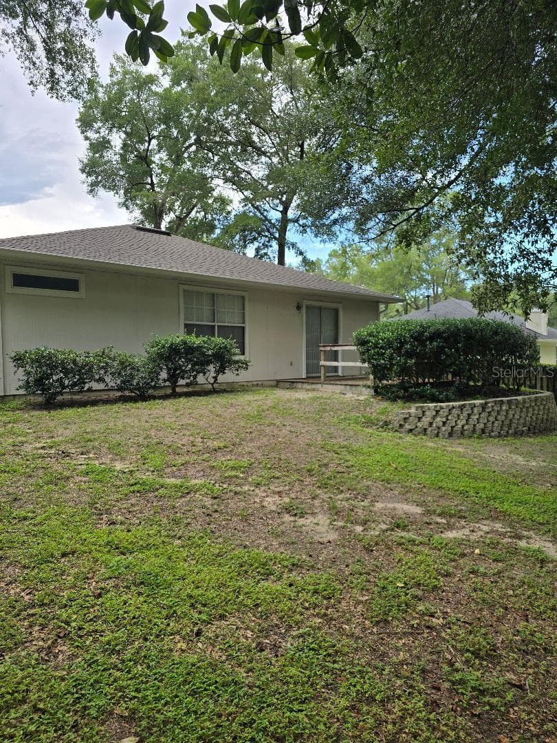 Back yard, beautiful raised design, wood deck, landscape provides privacy - 13607 NW 135 DR, ALACHUA