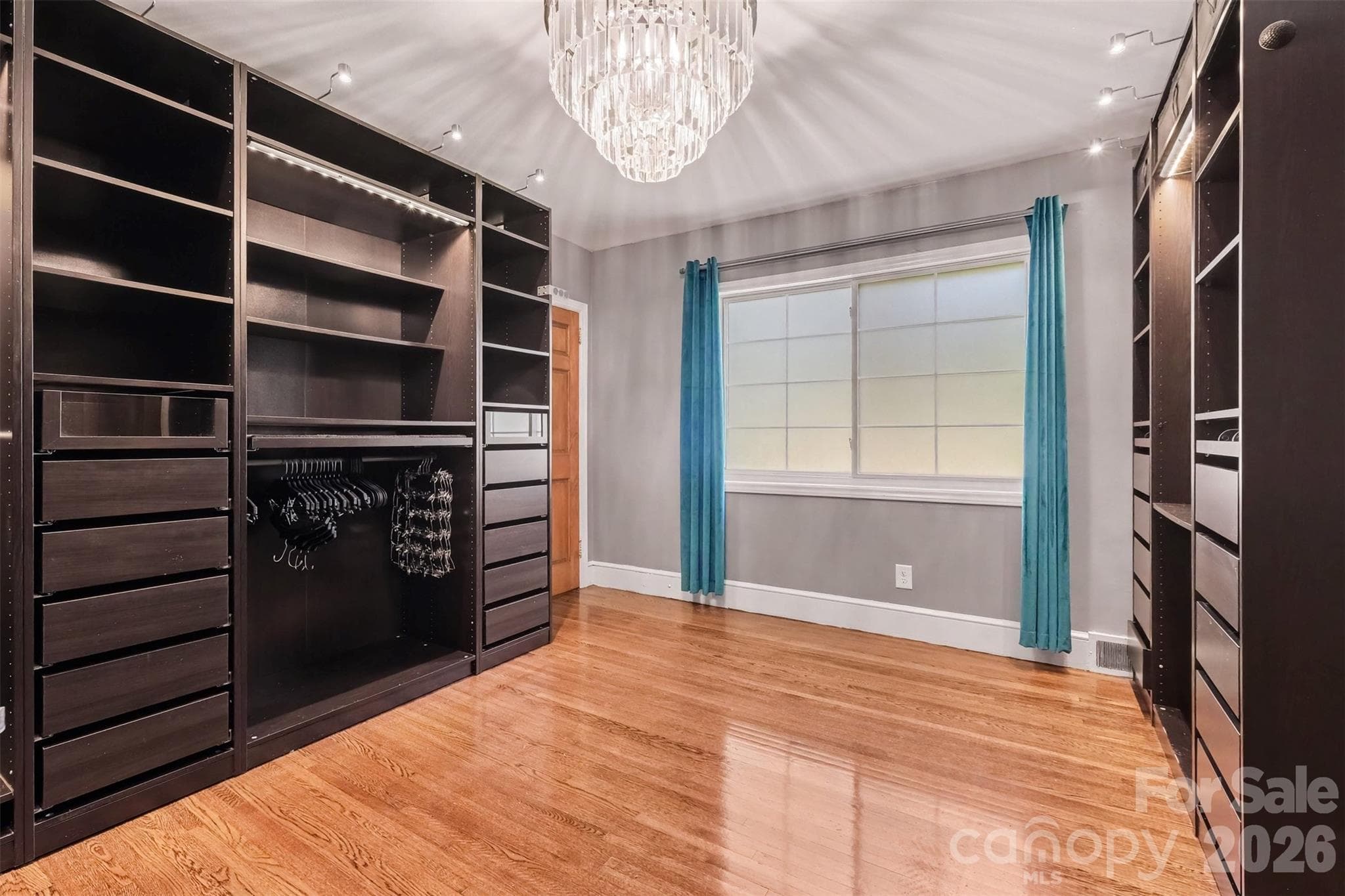 Bedroom 2 on Main Previously Primary Closet with Custom Built-In Shelves - 5914 Hanna Court, Charlotte