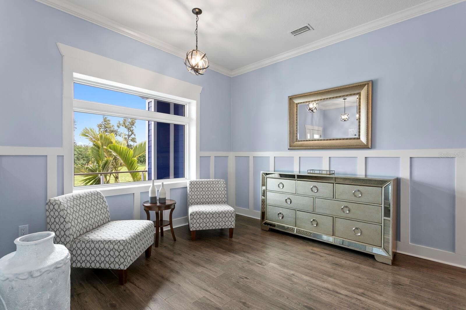Living room features large portrait window and crown molding - 704 EAGLE LN, APOLLO BEACH